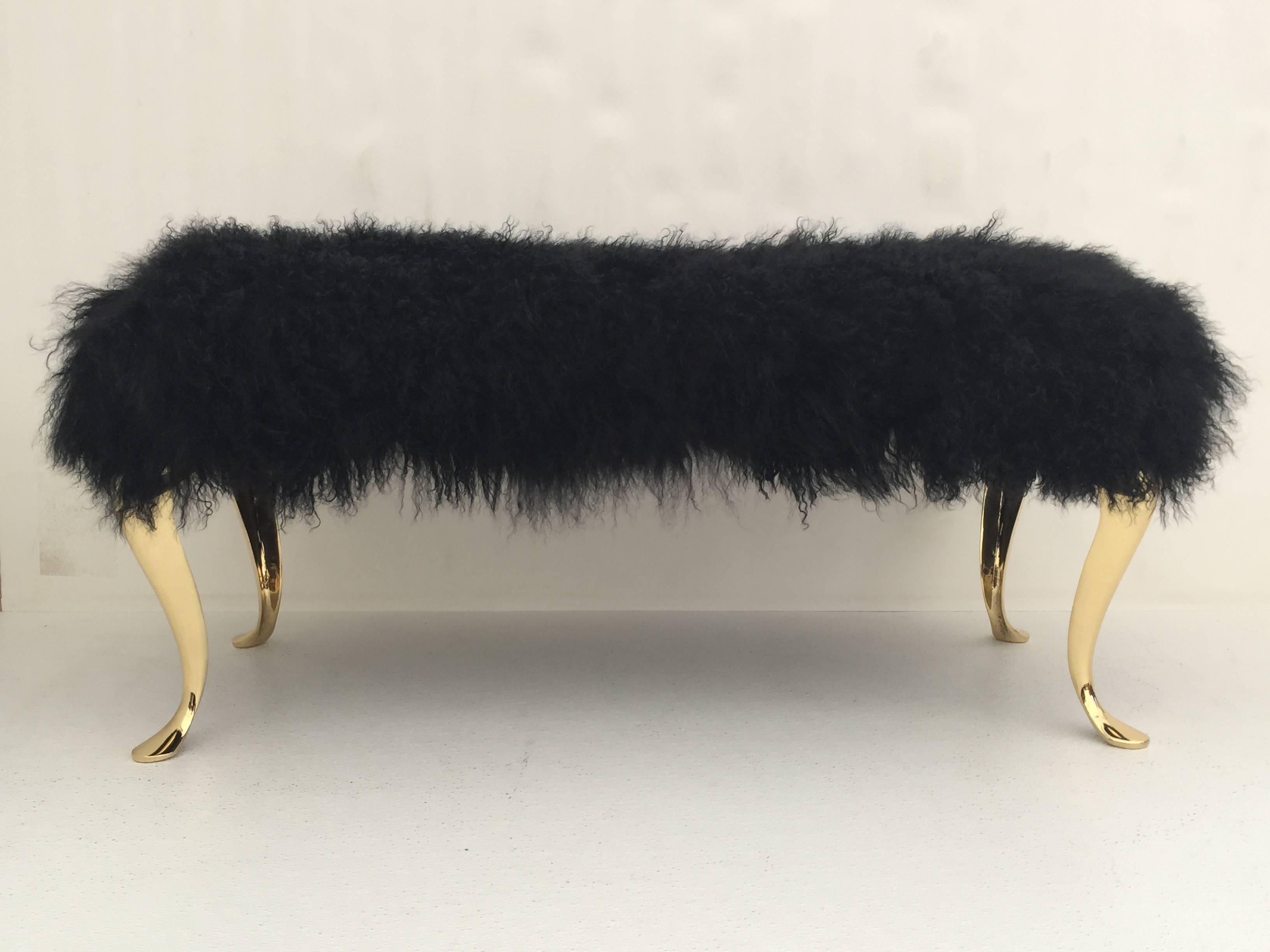 Glamorous black Mongolian fur bench or footrest with polished brass legs.
Brass legs are vintage 70s made in Italy and upholstery is new in Mongolian lamb wool.