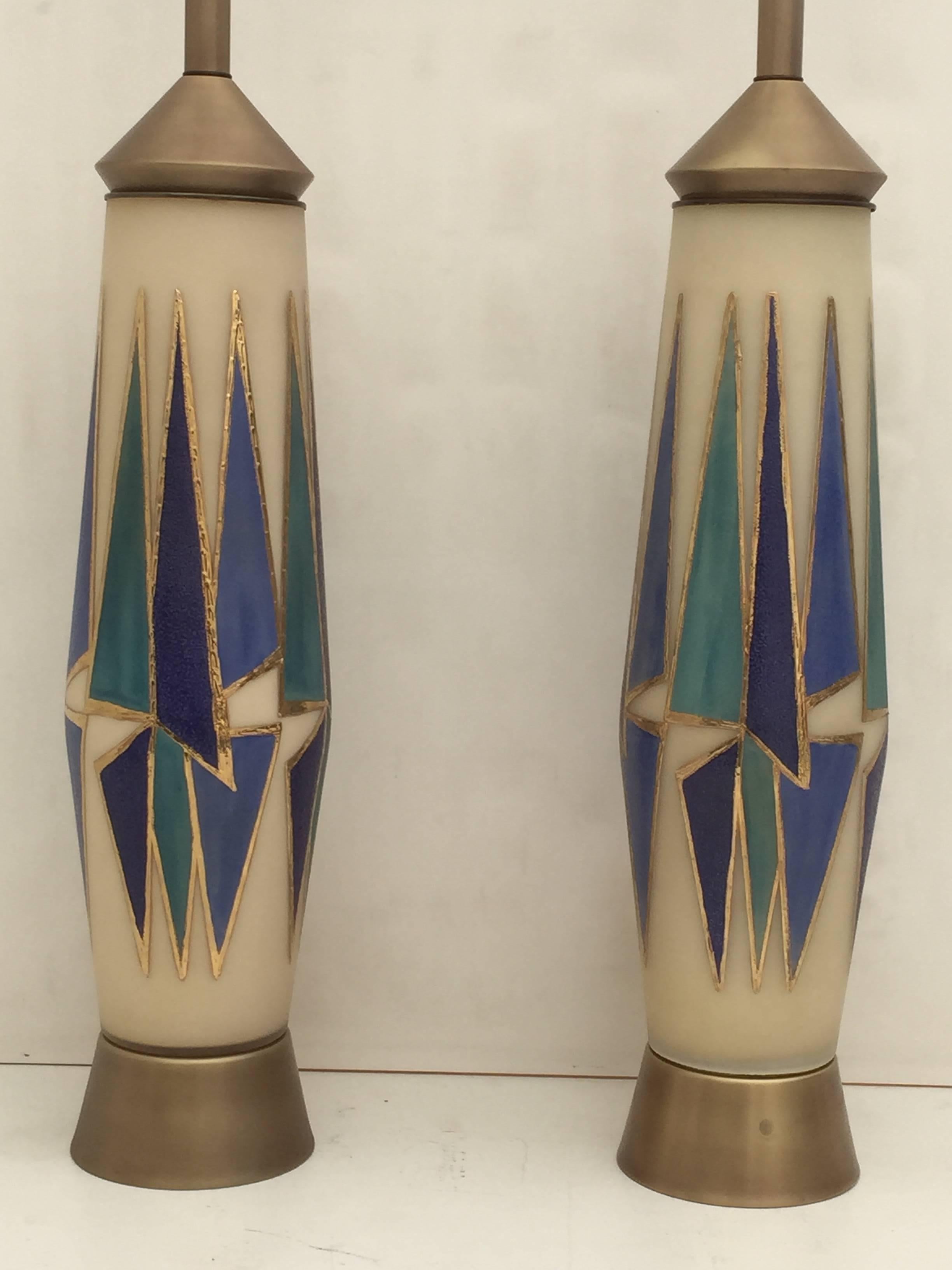 Pair of Mid-Century Modern giant opaline glass lamps with antique brass hardware and abstract gold and cobalt blue design.