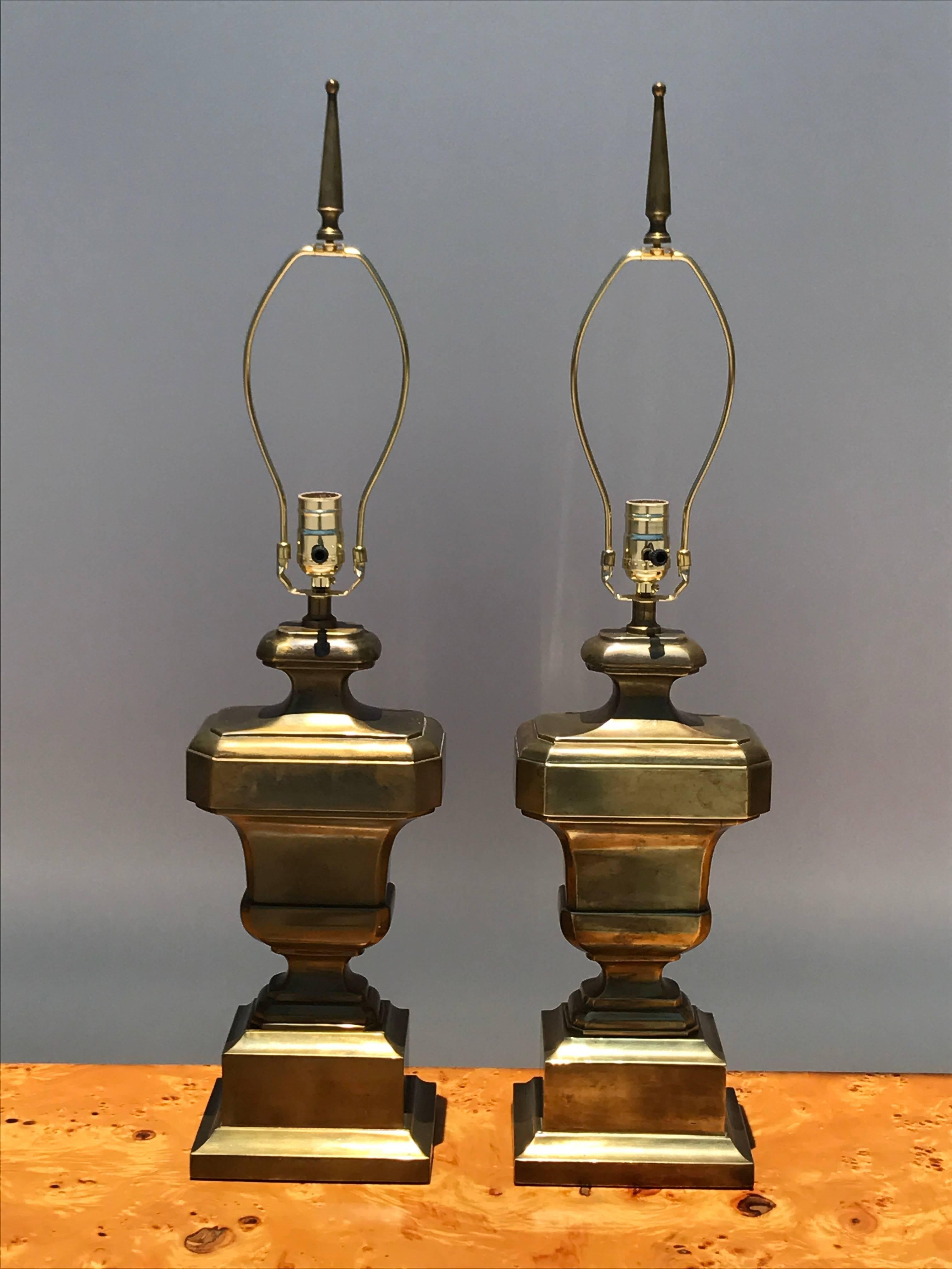 Pair of neoclassical urn patinated brass lamps with original shades.
Lamps without shades measure 31 high, 7.5 wide and 5.5 deep
One shade is little darker in color but once lit doesn't show the color variation.