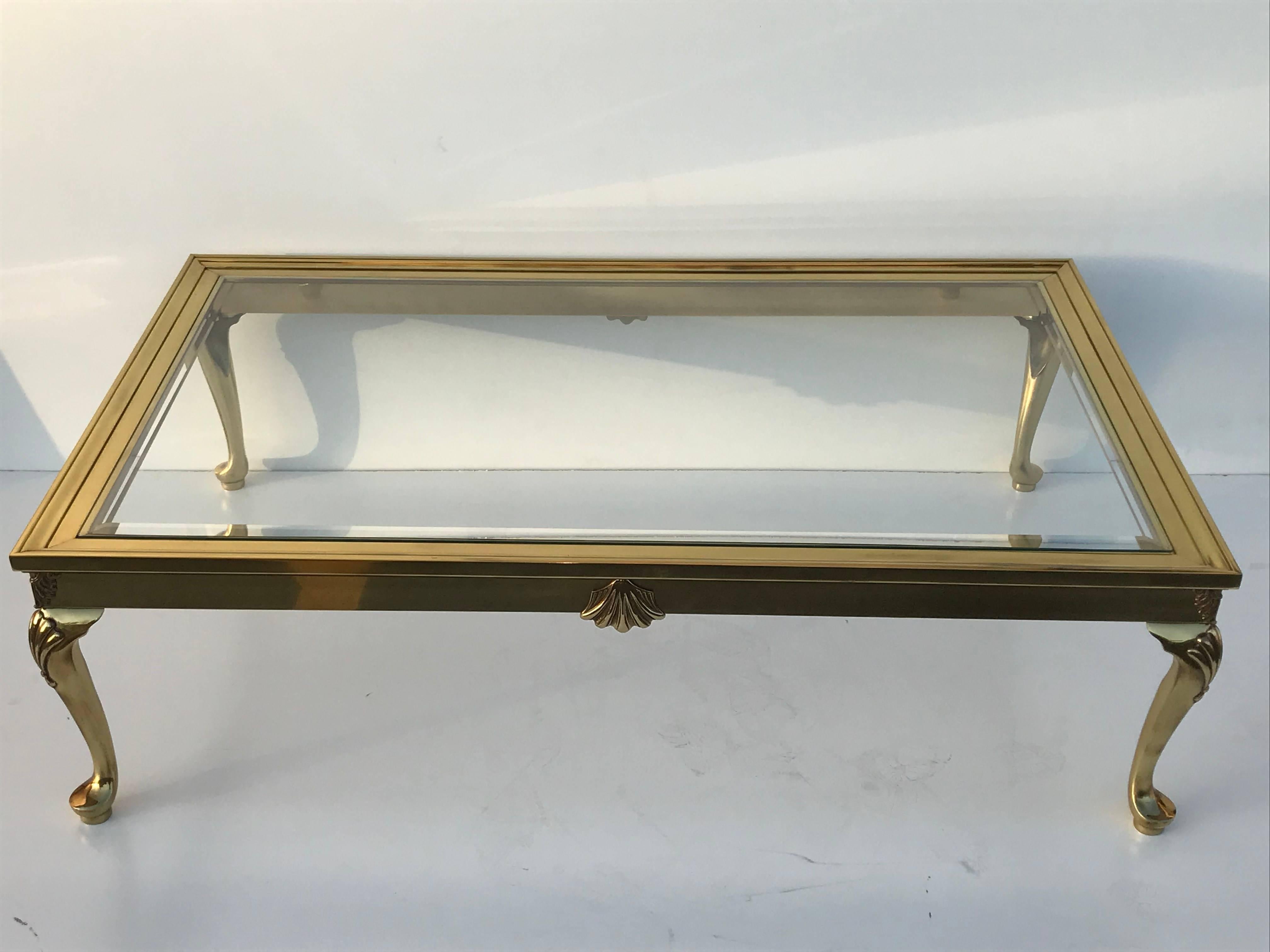 Cabriolet leg brass coffee table with bevelled glass top.