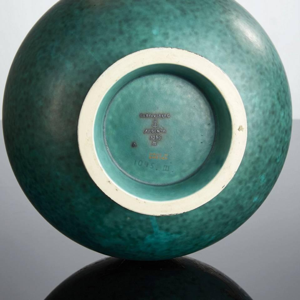 Signed "Gustavsberg Argenta 1045 III made in Sweden, D", Height 25,5 cm. Turquoise glaze with silver application of dragon. Exact year of production unknown, 1930-1957.