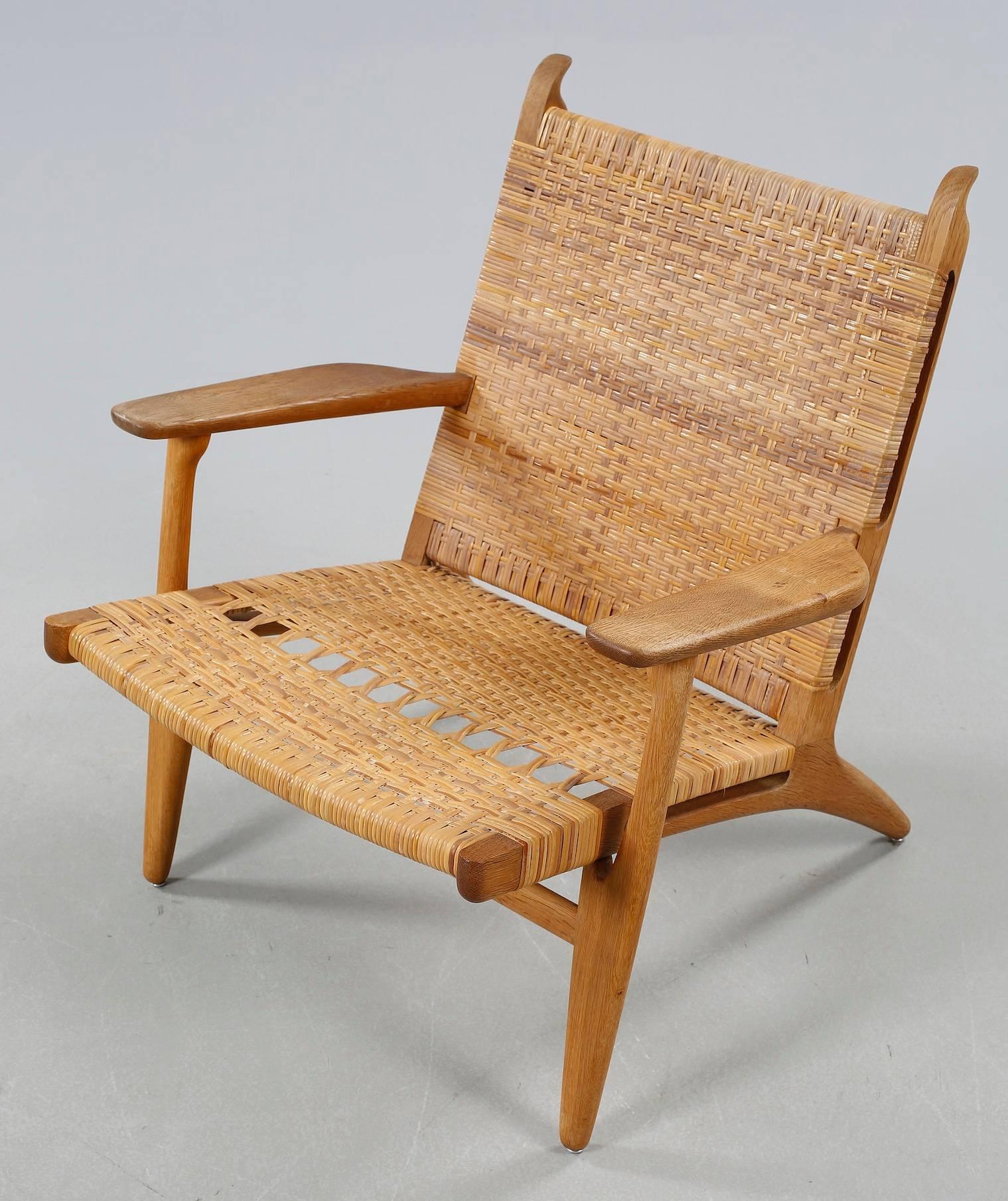Original Hans J. Wegner CH-27 chair in oak and rattan for Carl Hansen & Son. Some repair on the rattan was done. Chair is in very good condition.