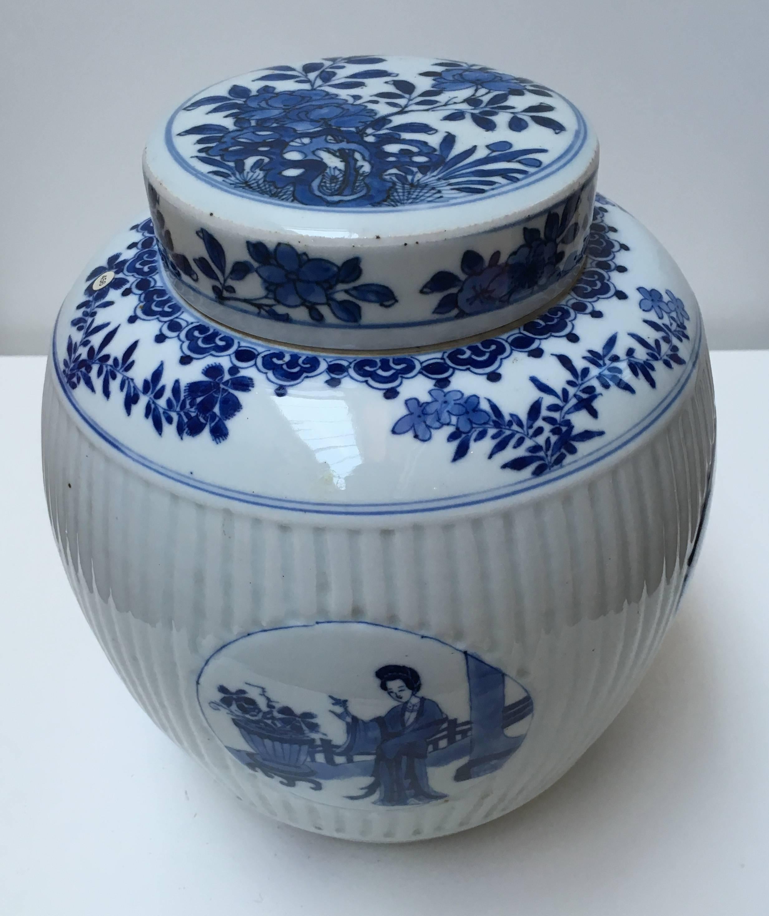 Ovoid, with ribbed middle section, the wide cylindrical cover over a short unglazed neck, decorated in underglaze blue with four medallions with scenes of two Chinese ladies. The top, bottom and cover decorated with floral motifs.

Comparative