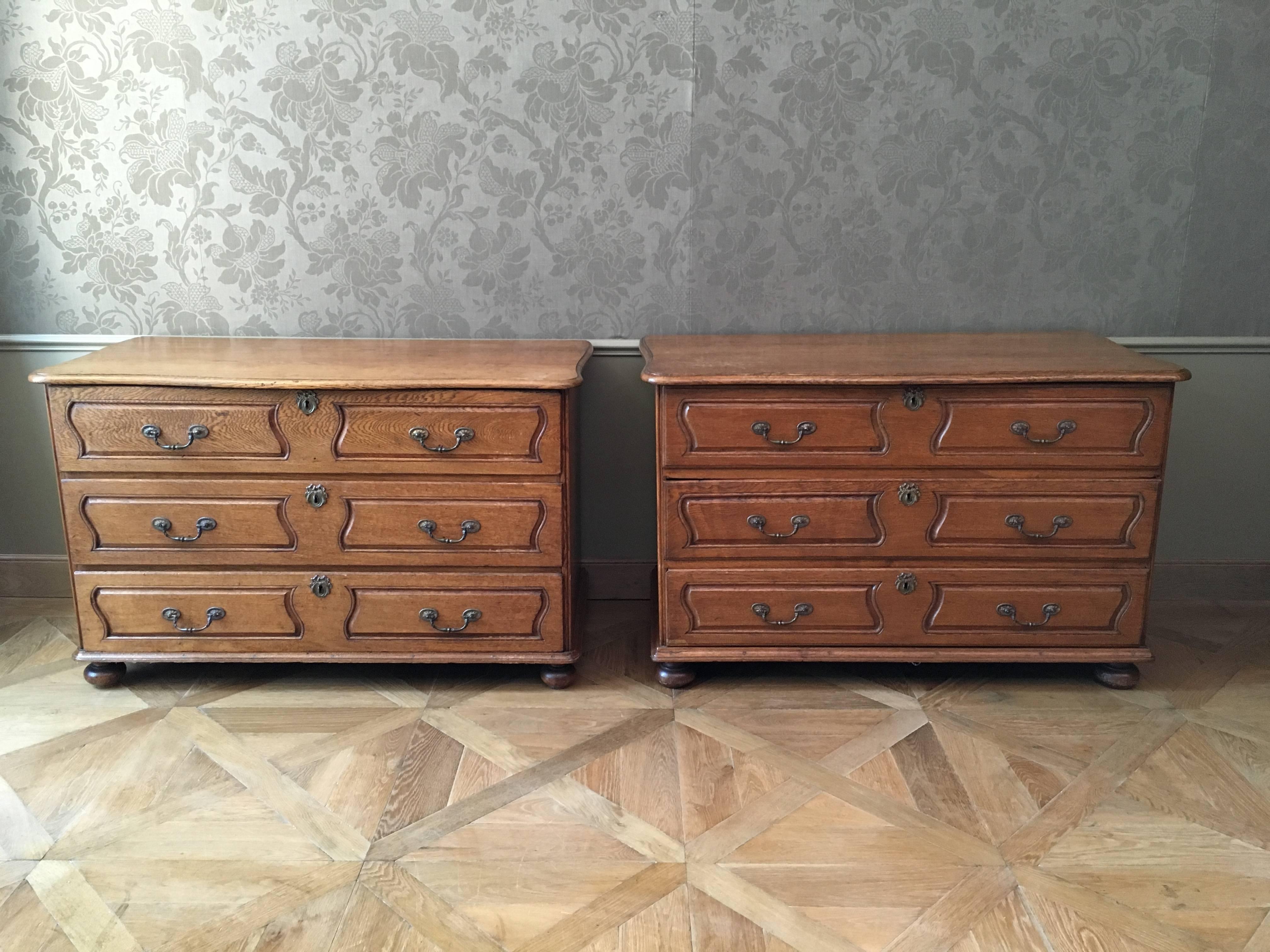 Each with serpentine top, three drawers, with bronze handles on four bun feet. 
Probably Southern Netherlands (Belgium) of Germany.