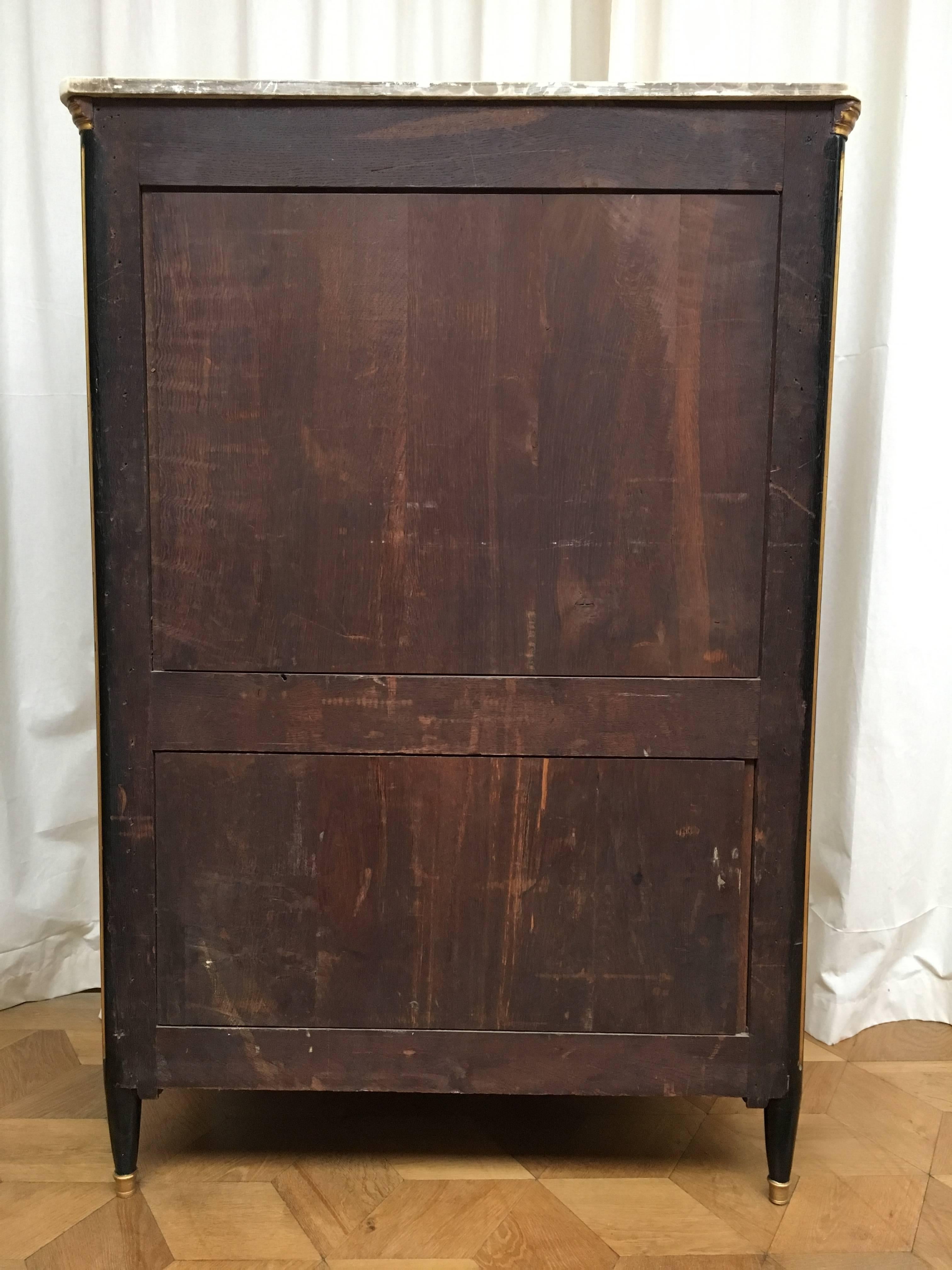 With a shaped white marble top (small repair and stains), the frieze containing one drawer above a fall-front enclosing a fitted interior with eight small drawers and shelves; the lower part fitted with a pair of doors revealing two small drawers