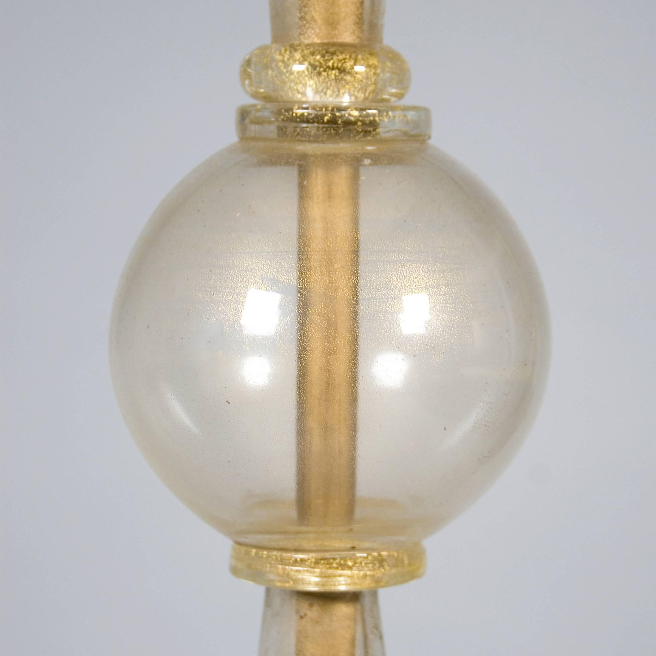 Simple glass floor lamp with gilt base by Seguso.