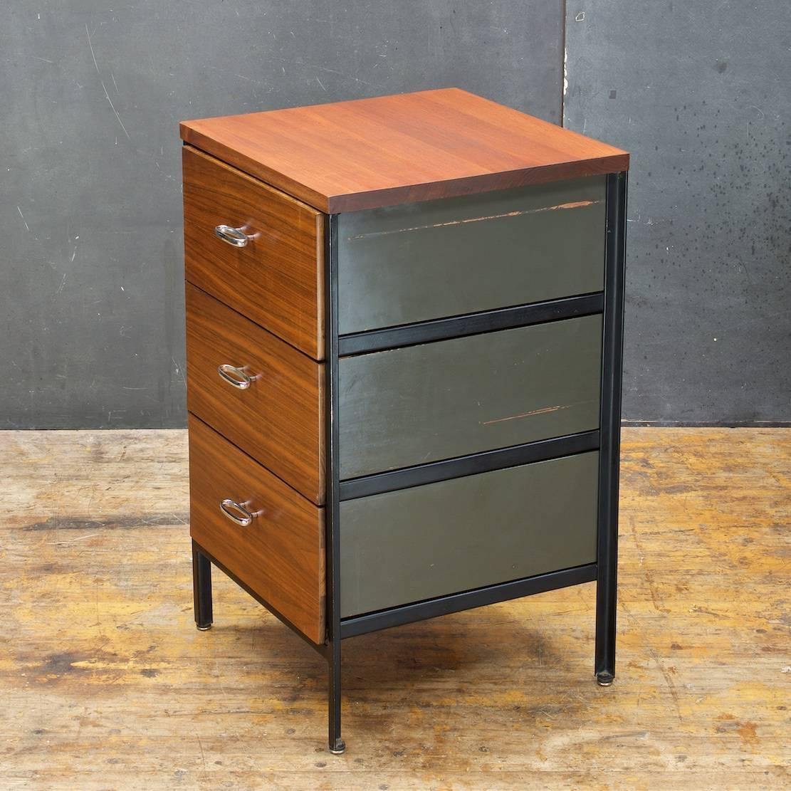 Solid hardwood top surface. Oiled walnut faced drawers and black enameled frame. Top drawer has removable wooden organizer, and herman miller medallion.

                              