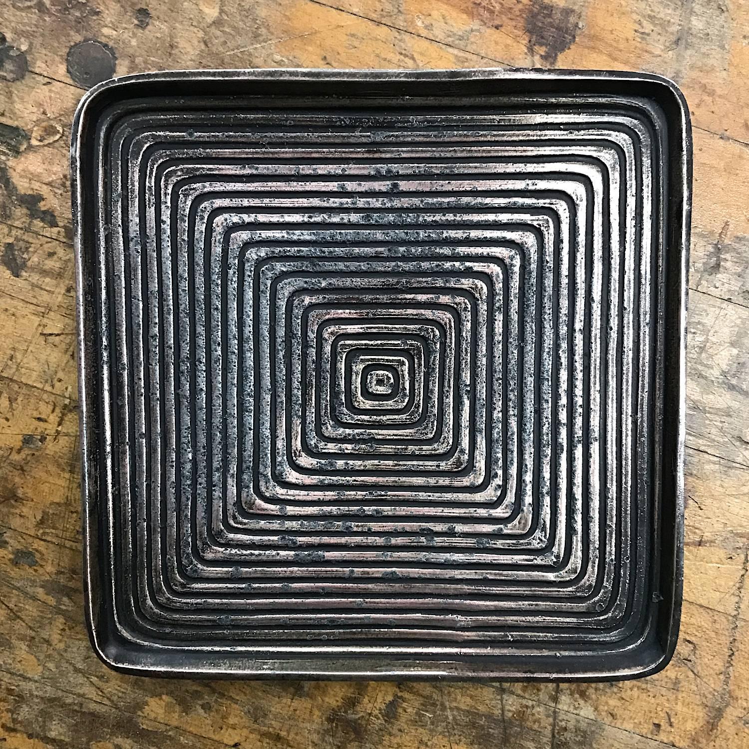 Brass toned cast dish plate or ashtray with concentric organic squares. Rare variation of the Jenfred produced designs.