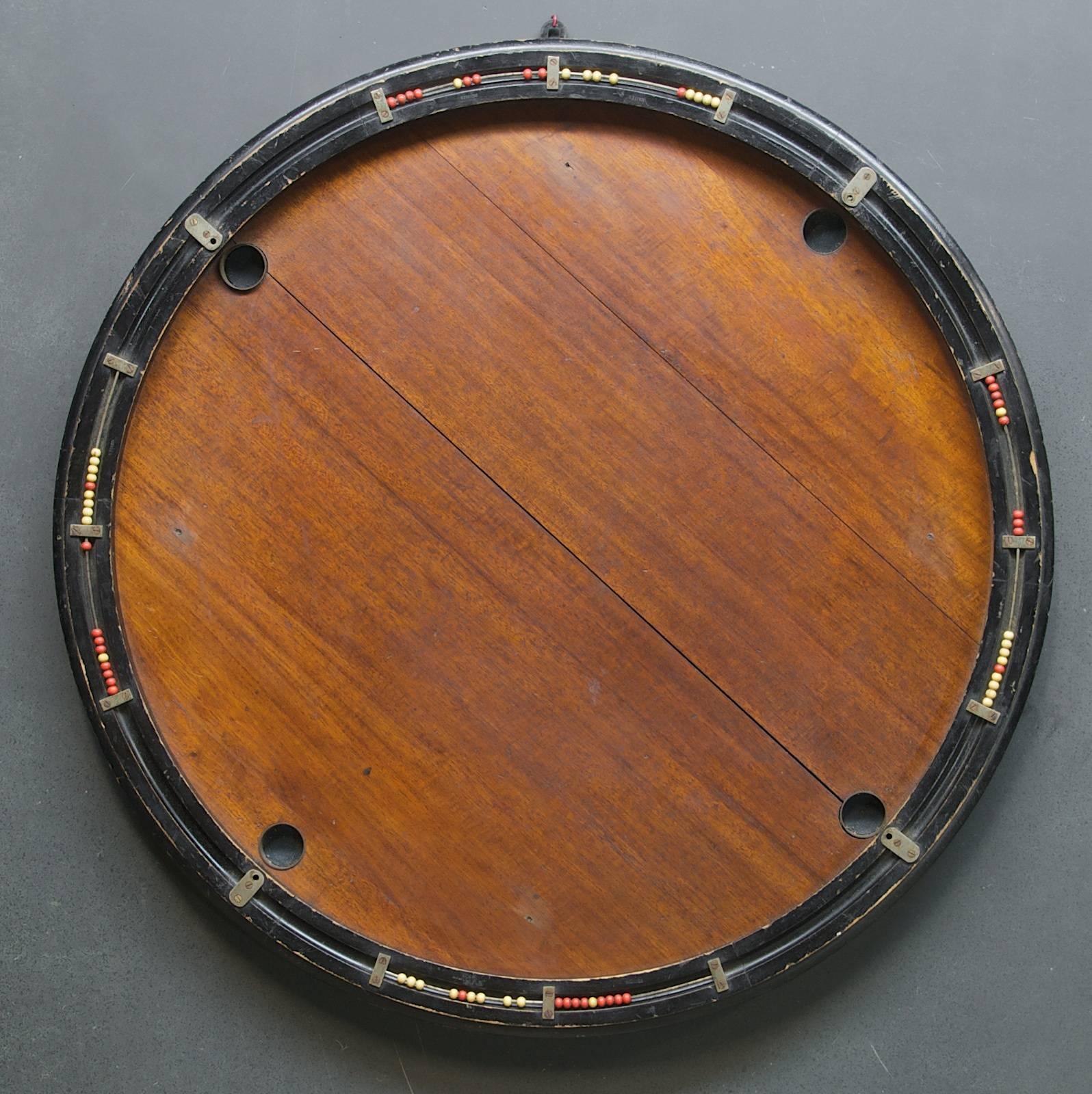 France, circa 1930s. French Parisian Billiards tabletop game board. With bakelite or catalin beads. 

Dia: 29 in.