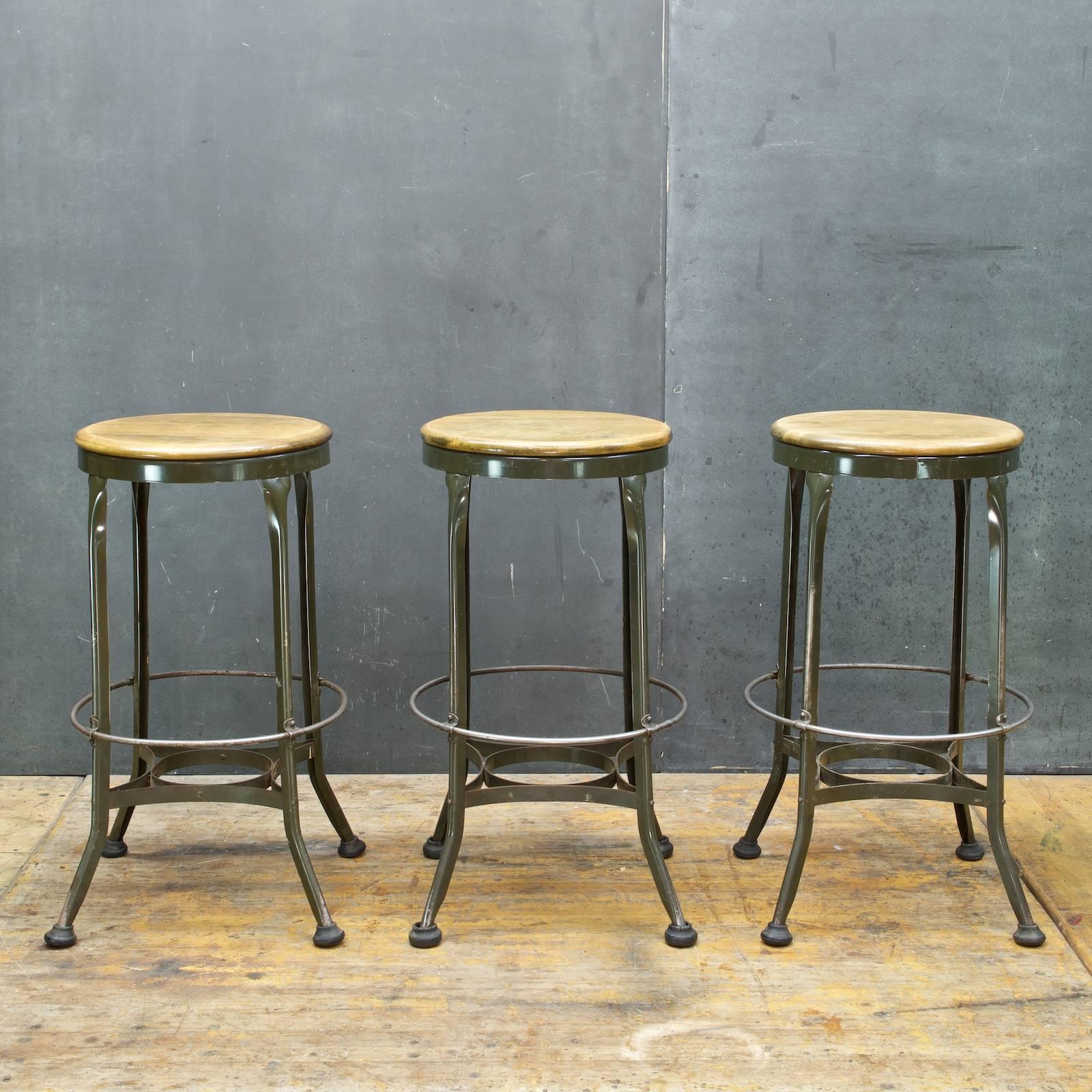 Set of three matching vintage tall toledo at a good bar height, overall in very good vintage condition. All fully functional, and each with all four of the big hockey puck glides!

Measures: Diameter 15 x height 29.25 in.