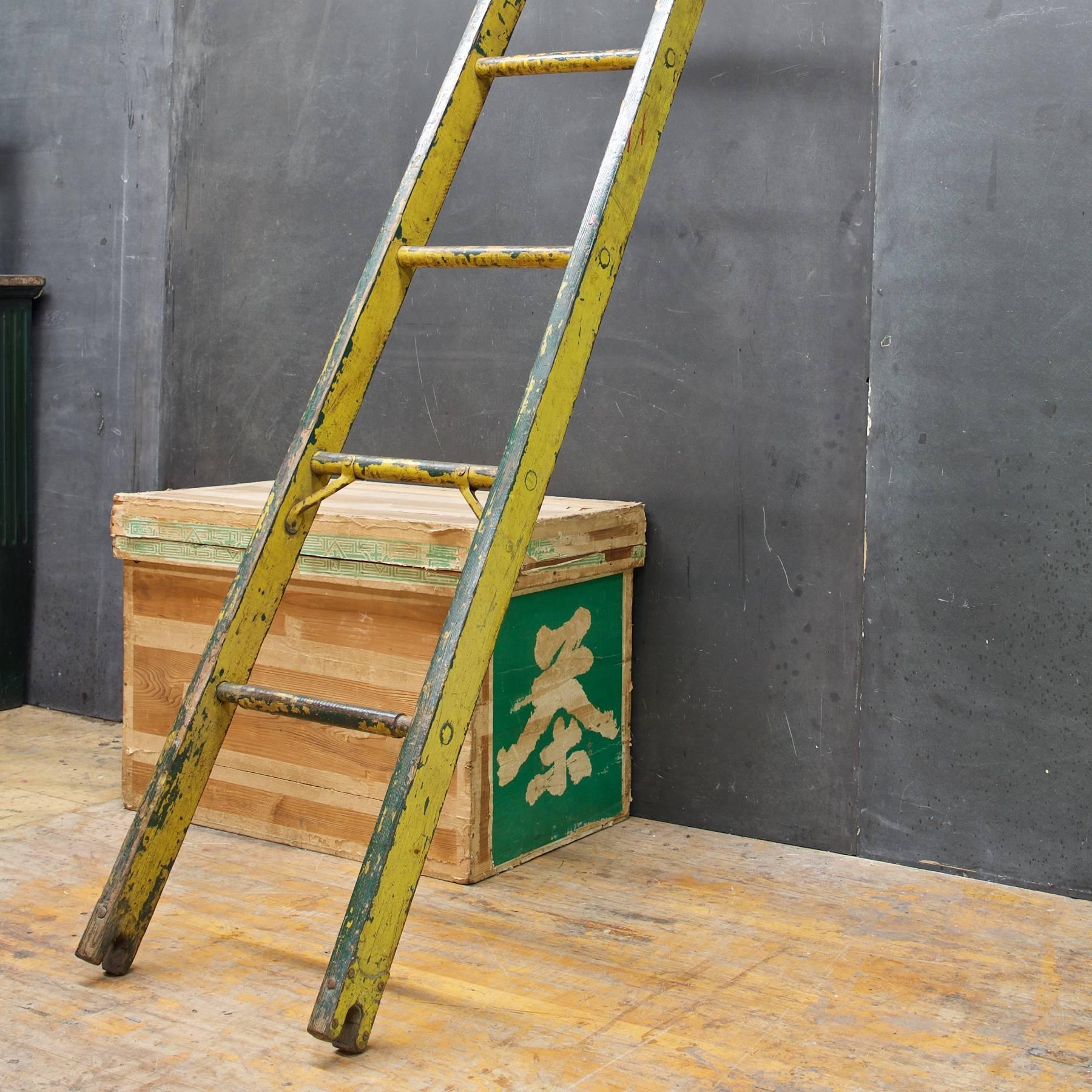 Rare antique Baltimore city enameled yellow early century lamplighters wooden ladder, with yellow, white patina, a few metal reinforcement details, forked ends were used for stacking additional ladder segments. 

Measures: Top W 12¼ x Bottom W 15¼