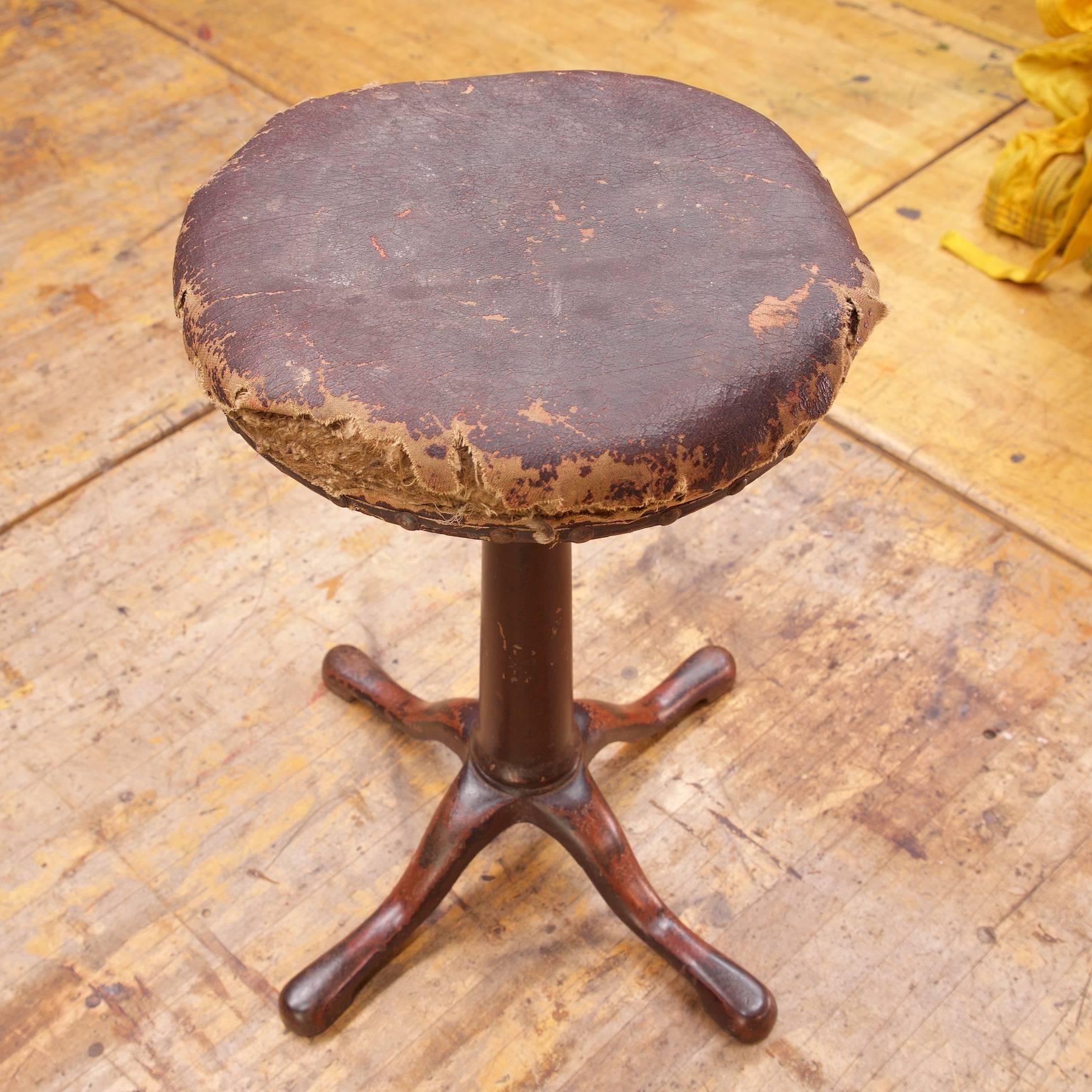 Ready for you to re-upholster to match your interior. Vintage industrial Cooper & Sons cast iron swivel piano stool. Fully functional. Tattered upholstery.