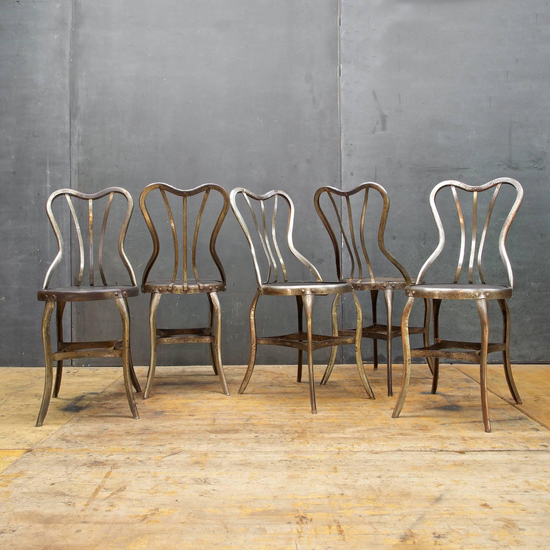 USA, circa 1920s. Industrial vintage Toledo Metals Company rare dining chairs. Set of four. Nickel chromed steel and enameled patina'd surface. Heavy steel construction. Very solid and sturdy. All tightened up, no loose joints.

Measures: W 14½ x