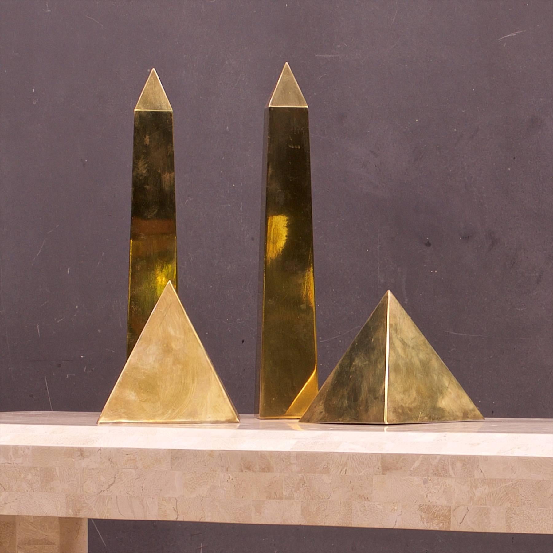 Sarreid Ltd. brass abstract shapes, Classic pyramid and column forms, Spain, circa 1970s. 

Measures: Pyramid W: 5 5/8 X D: 5 5/8 X H: 5 5/8 In.
Obelisk W: 3 x D: 3 x H: 12.63 in.


