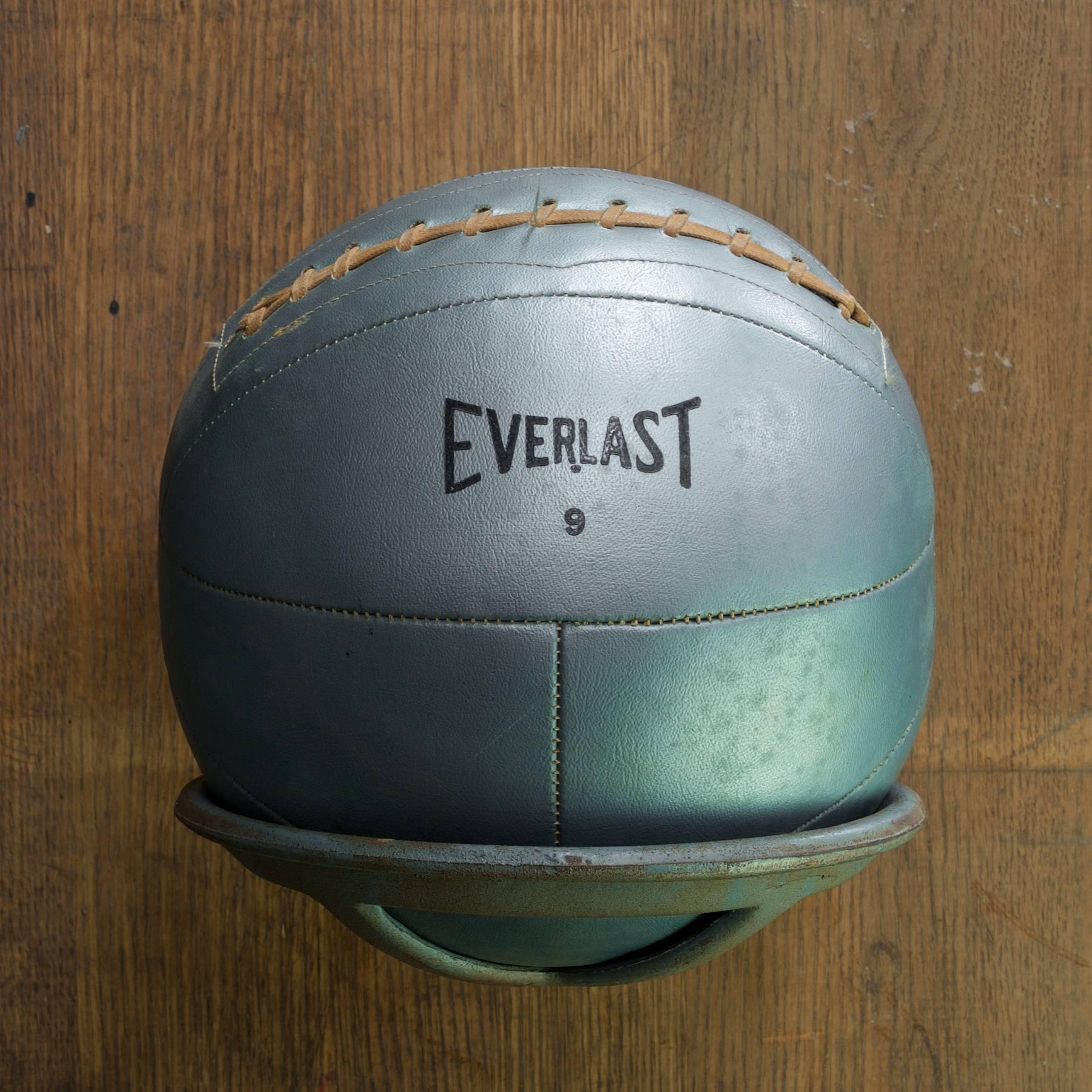 Vintage Everlast ball no.9. about 14 lbs. It does not appear to have been opened and restitched. Blueish-grey in color with black print. Dimensions: 9.5 in. (Add 3 in. for Mount.).

 