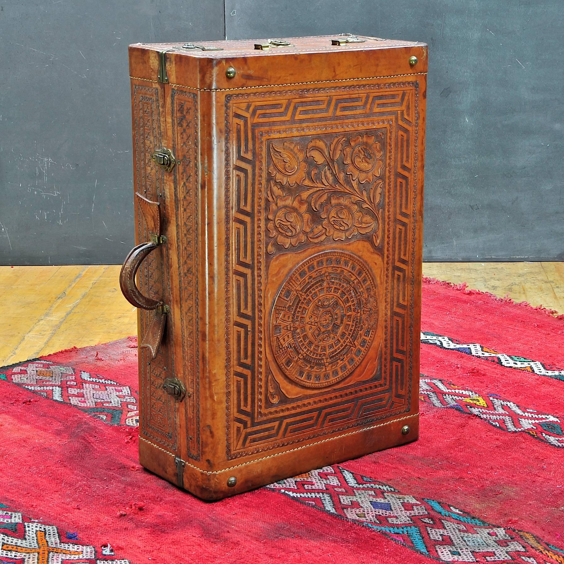 A souvenir, relic from an old Mexican Excursion. Vintage handmade wardrobe suitcase, hand-carved or impressed leather. Good vintage condition, showing some wear and staining, consistent with age. 

Measures: Width 29½ x depth: 19½ x height: 10 in.