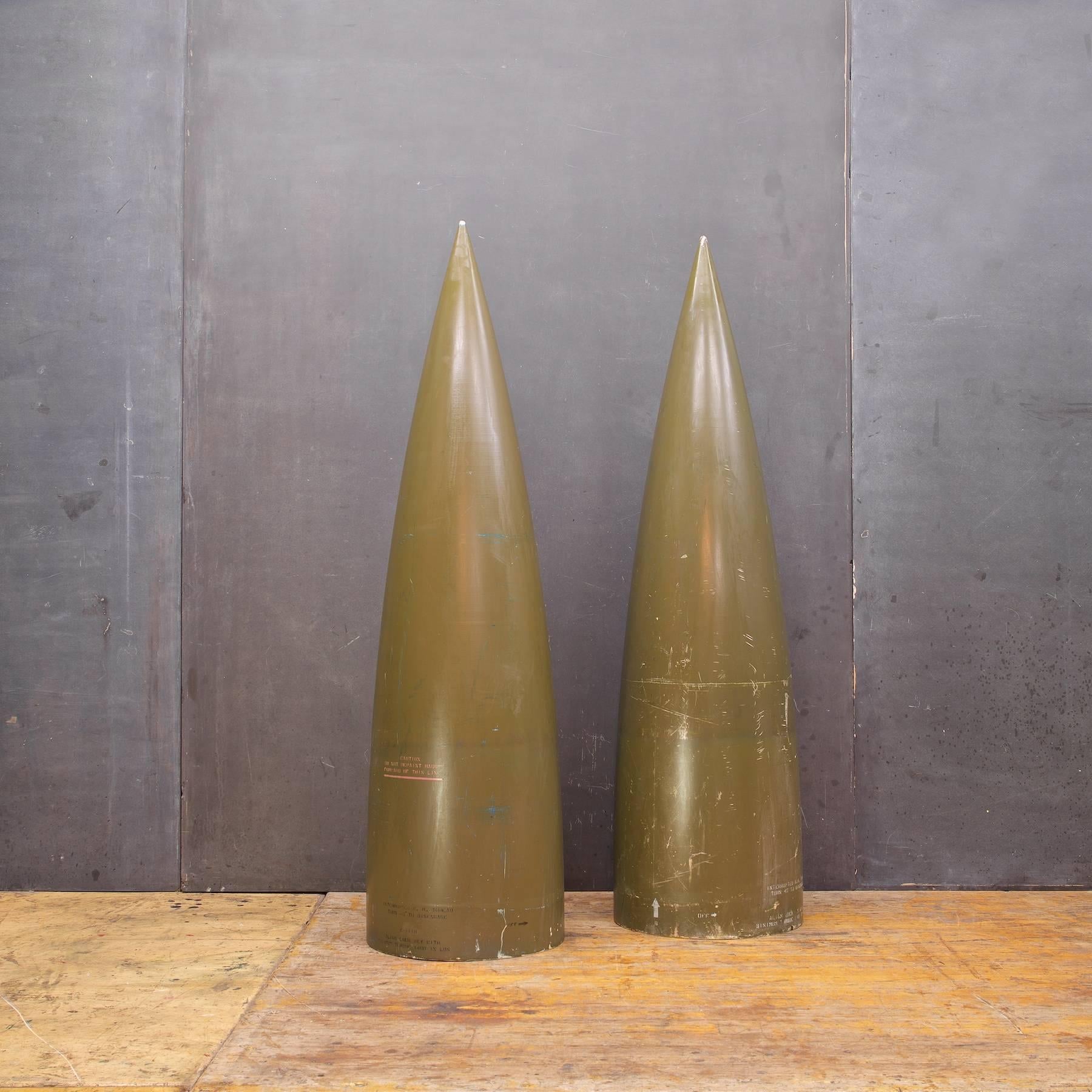 Vietnam era howitzer rocket/bomb/casings as sculpture. Enameled fiberglass resin polymer material. Great props, NoseCones as sculpture.