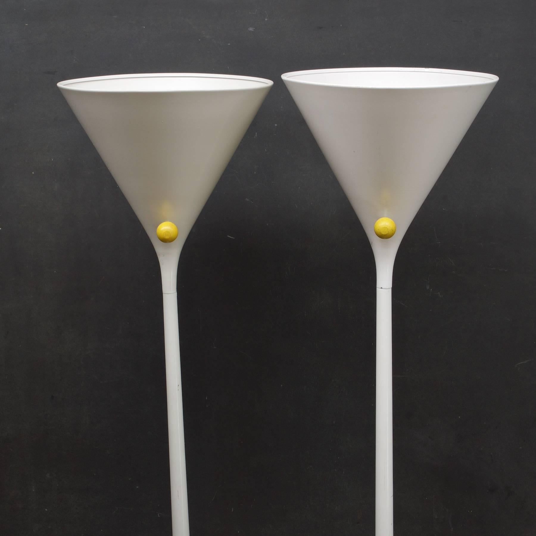 Great pair of matching conical floor lamps, old Hollywood style, with yellow clown nose switches, one retains the original label on base.) Sold in a set of two.  Tops of Bases are show some wear.