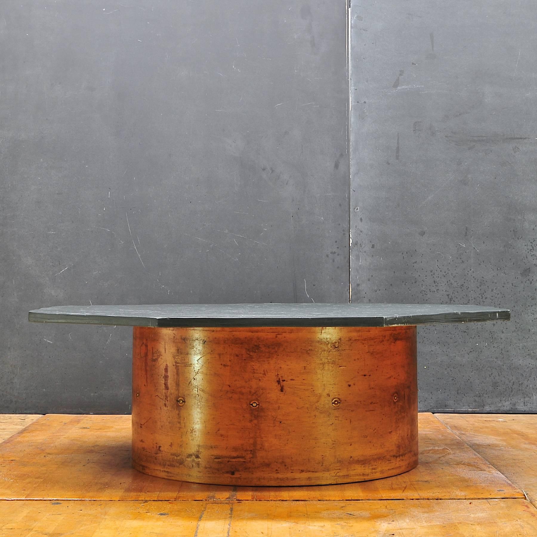 Solid textured slate surface on copper toned maple cylinder with brass detailings.