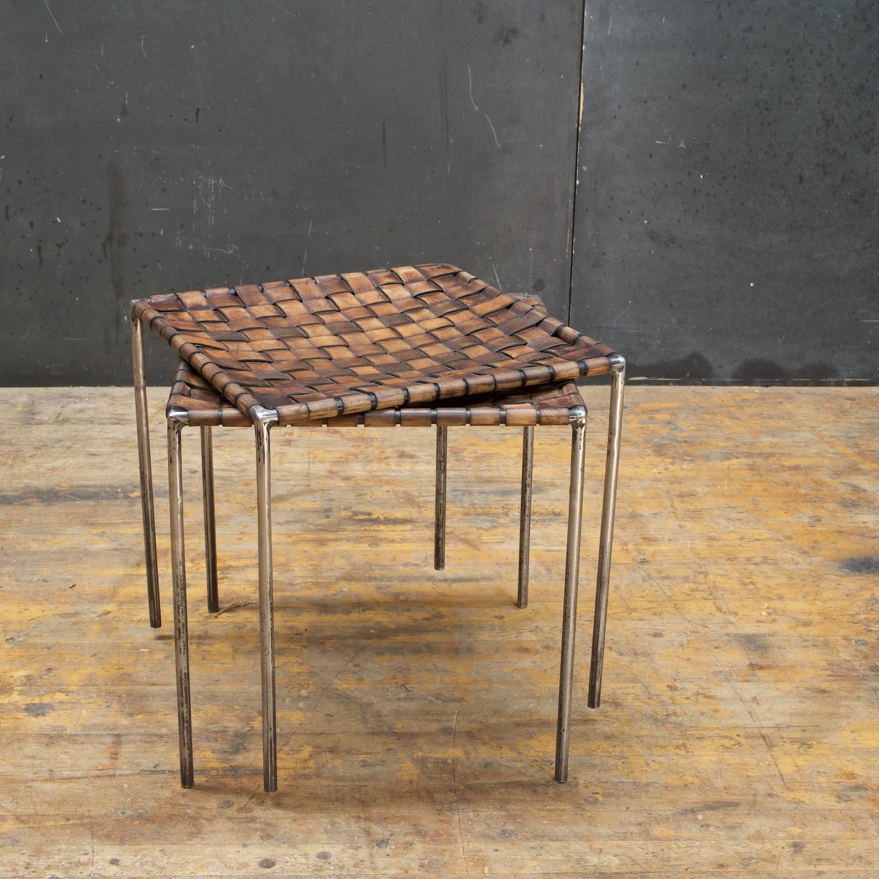 Beautifully patinated midcentury low seats with a semi-polished welded iron rod cube frame, and lattice webbed leather strapping.