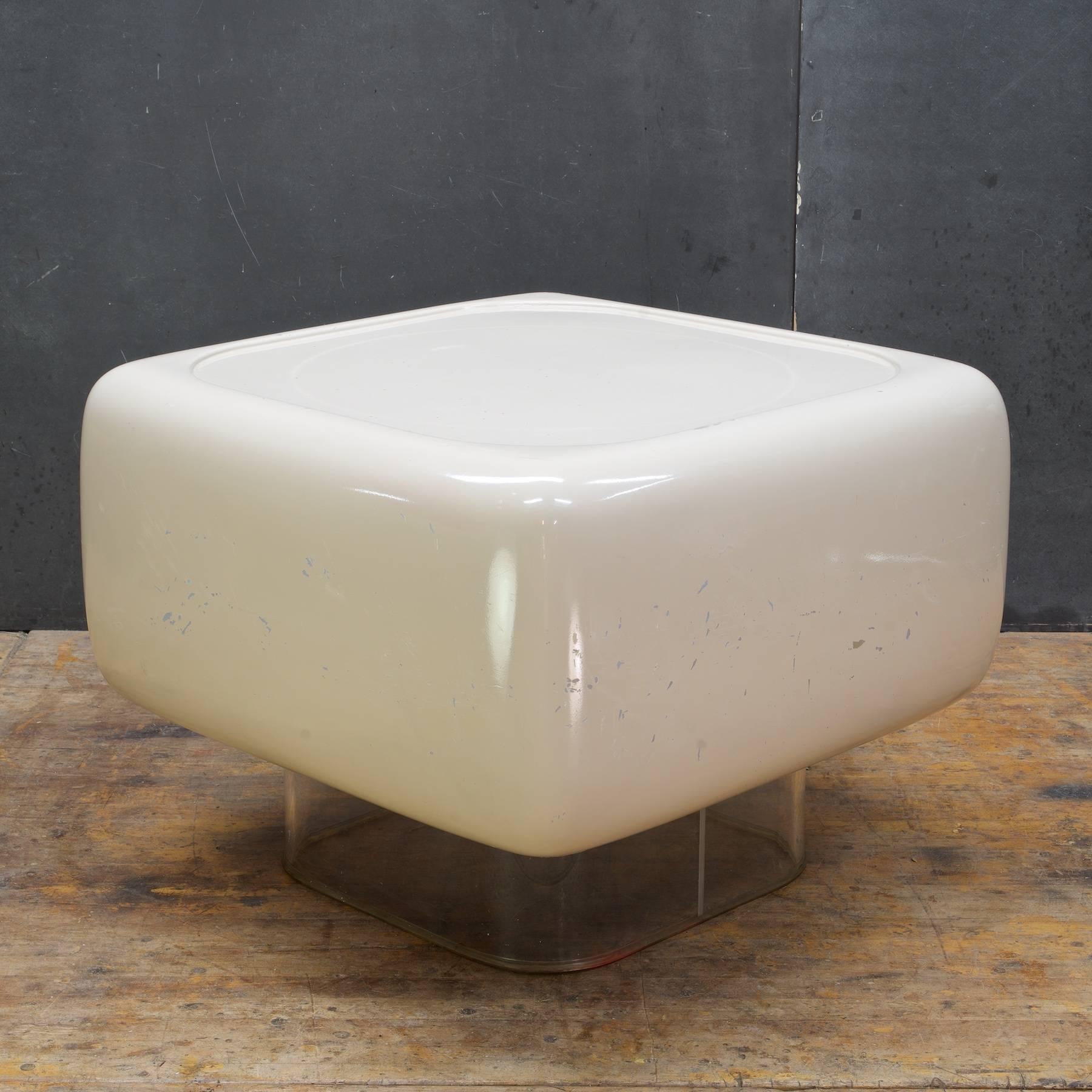 Uncommon beauty in this Post Modern design on transparent pedestal. 

We are offering this item in as-found condition with patina/chipping and scuffing to original off-white enamel surface. This levitating cocktail table could be painted to fit your