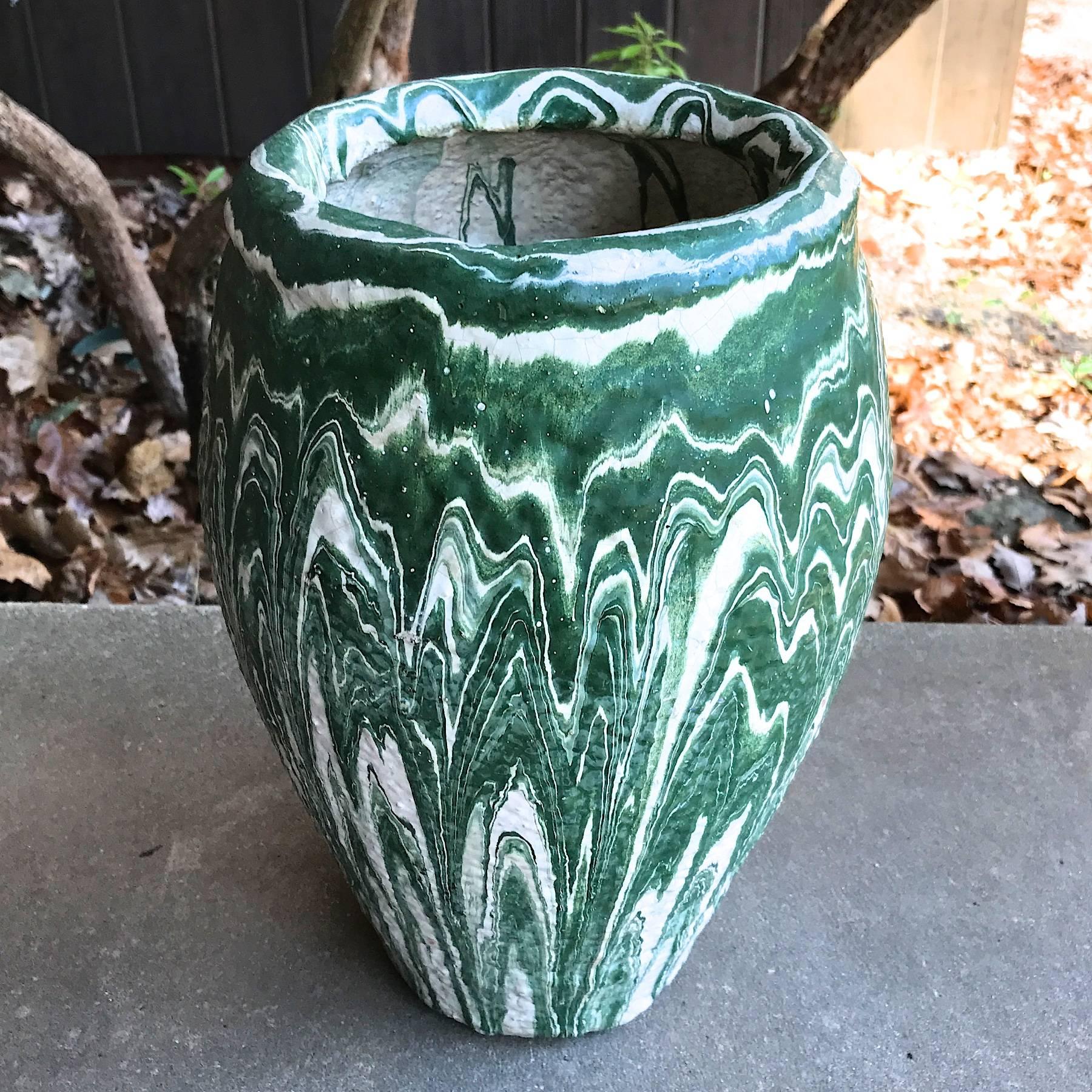 13.5 Inch tall Niloak Pottery Co. Vase in Green and White Swirls. The Niloak Company was founded by Charles Dean Hyten and located in Benton, Ark., from 1909 to 1947. They began making crocks, jugs and churns. When demand for utilitarian ware waned,