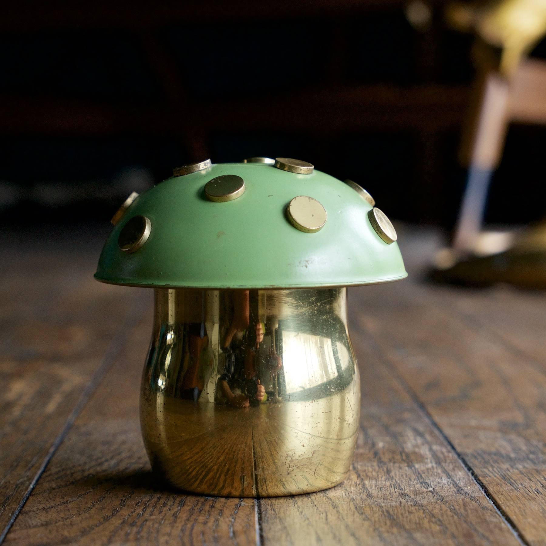 The domed lid of this Mushroom container is enameled in sage green with raised brass polka-dots, the bottom is polished brass. This example is lined in felt, but can be easily removed. Uncommon and playful form.