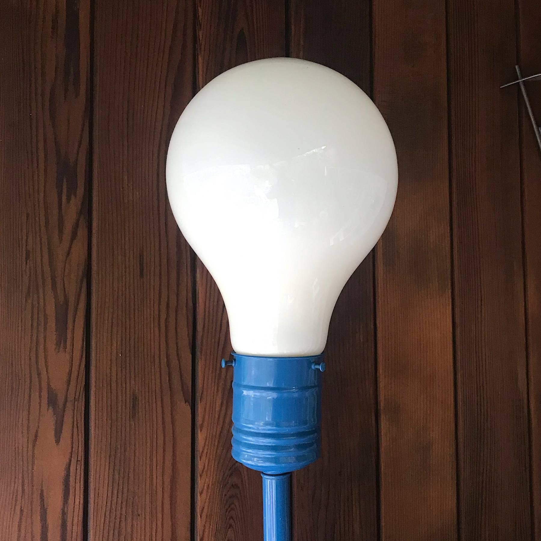 Enameled blue on steel, with white glass light-bulb shaped domed diffuser. Good vintage condition, showing patina and slight oxidation to base, wiring and switch are original, and very good.

American copy of the famous Ingo Mauri light bulb lamp