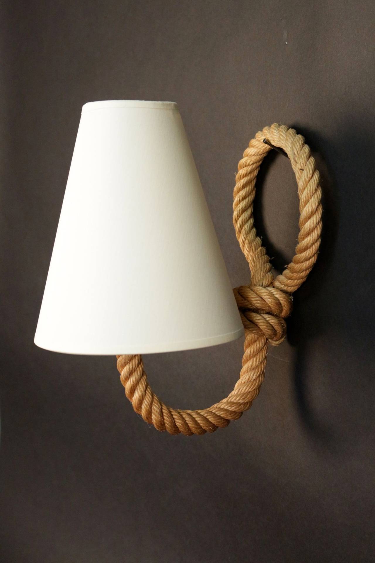 1950s set of rope three sconces by Adrien Audoux and Frida Minet
One lighted arm per sconce. 
New lamp shade.
Adrien Audoux and Frida Minet are known for their rope lights and furniture. Their first workshop have been founded in 1929 at