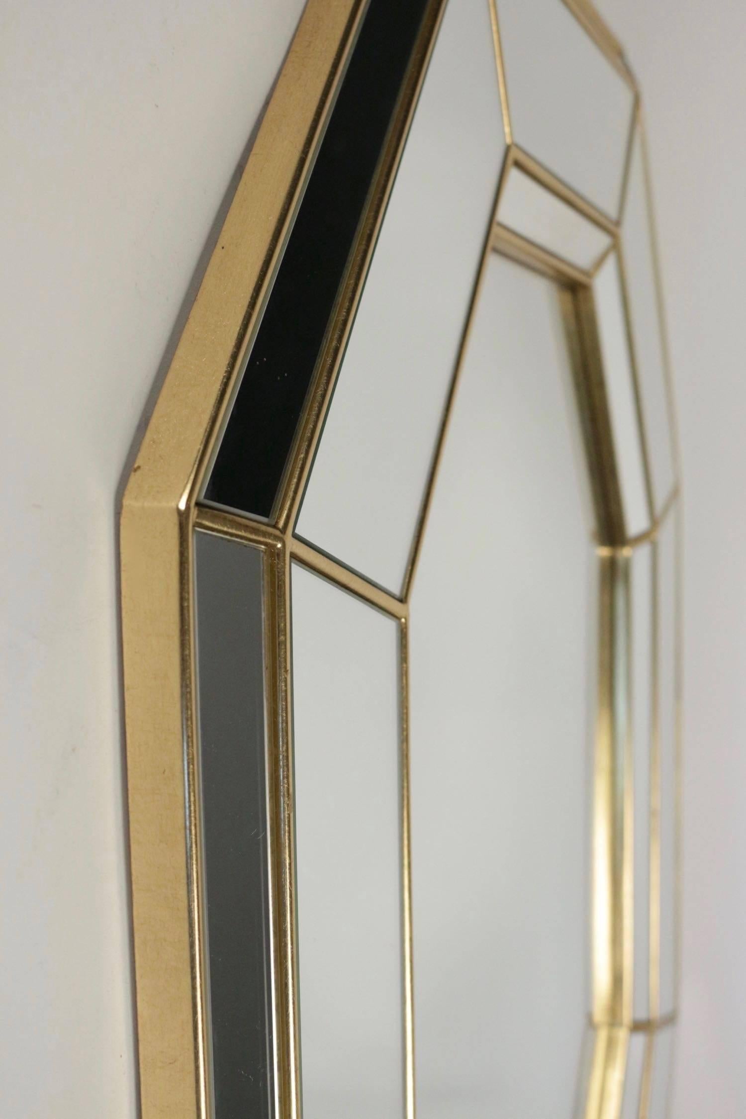 1960s cut edges mirror by Maison FlorArt.
The border of the mirror consists of eight mirror sections, with matching inside and outside mirror cuts. The set is assembled and underlined by thin giltwood sticks. In the center an eight cut edges mirror.