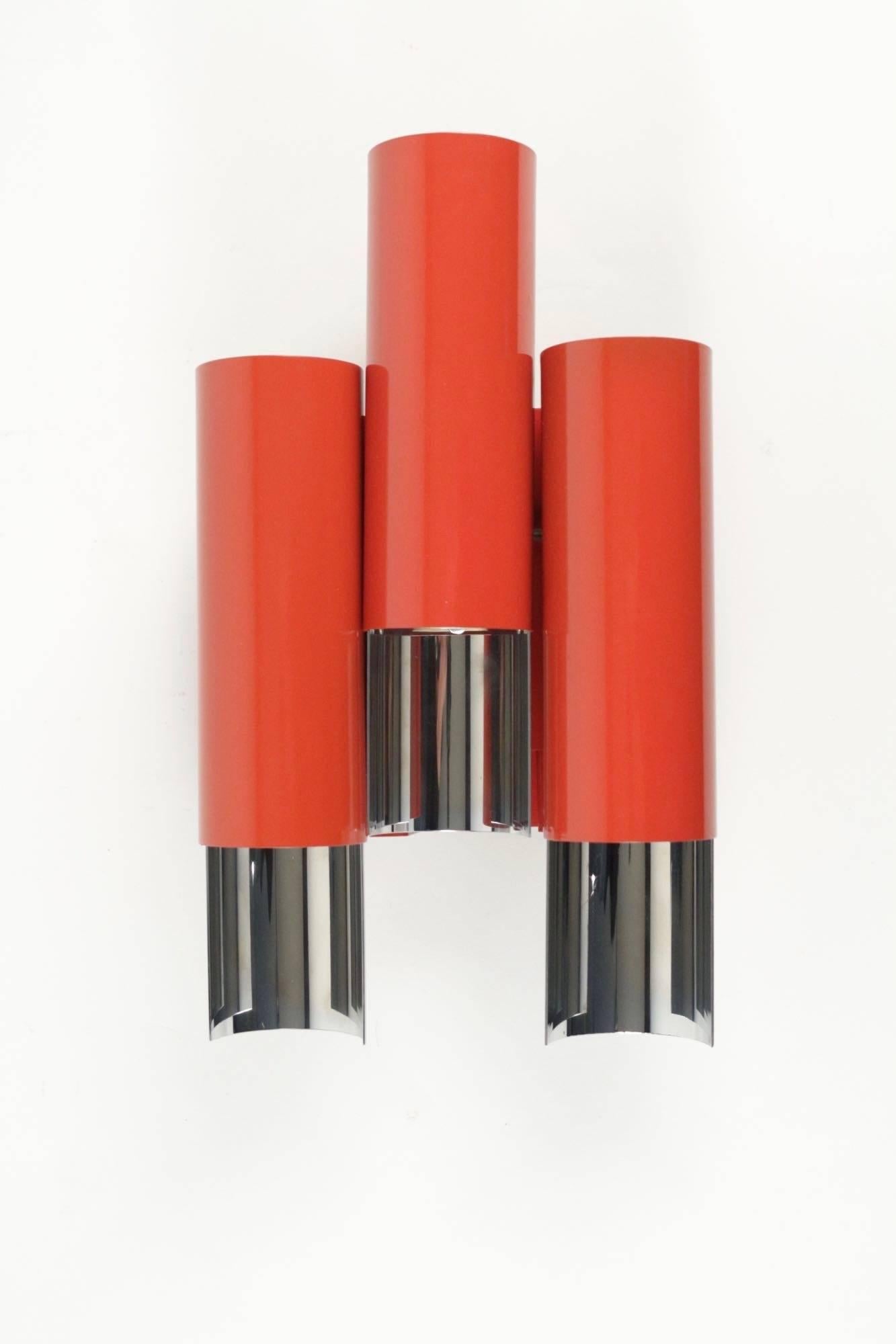 1960s Stilnovo red and chrome pair of sconce. 

Composed by three red tubes ended by chrome reflectors. 
Signature Stilnovo located below each sconce. 

Three bulbs.