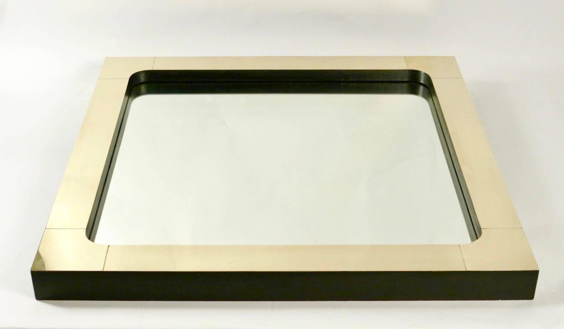 1970s square brass and blackened wood mirror.

The corner of the glass are round. The frame is made of blackened oak which brass plates.