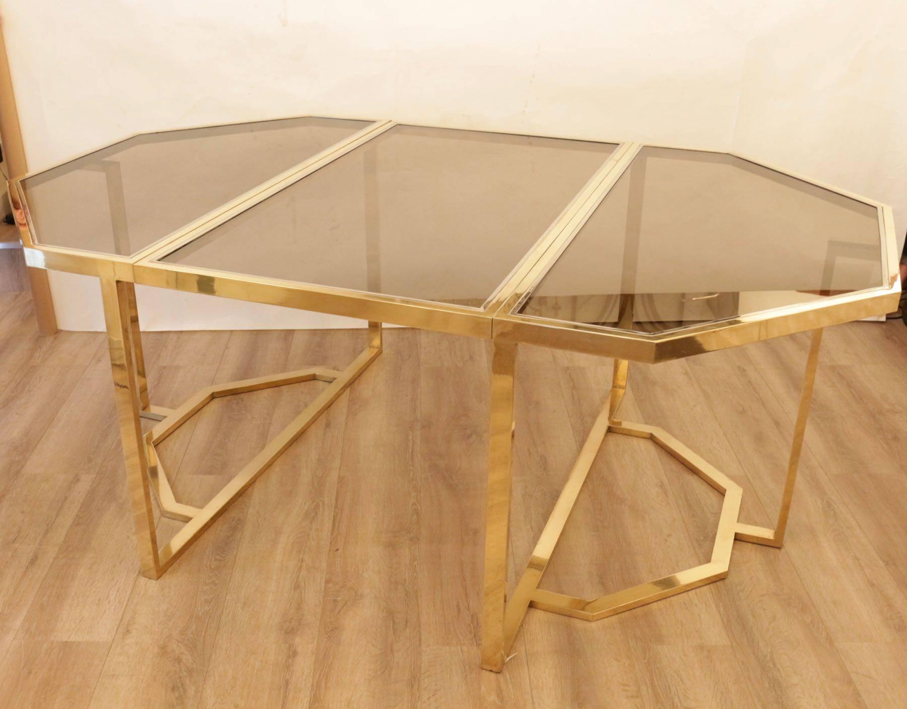 1970s extending dining table, brass and chrome, Romeo Rega.

Octogonal table made of brass and chrome with smoked glass top.
A centrale extension can be deployed.

The table can also be used as two consoles tables.
Ingenious system, Italian