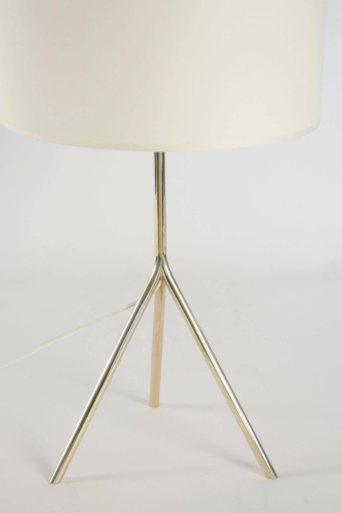 1950s gilded brass table lamp
Tripod base lamp made of gilded brass. 
Handmade lampshade of off-white cotton granted to the original.
One bulb.