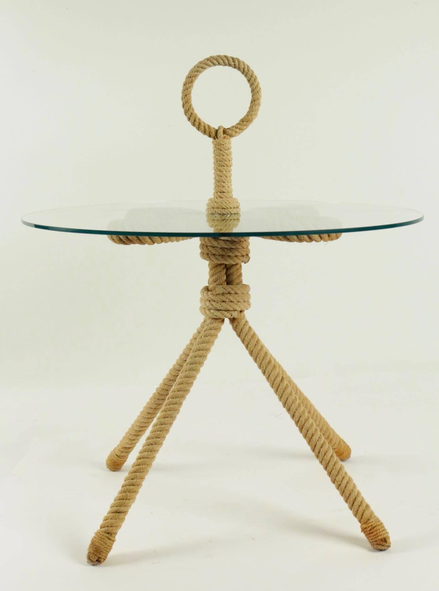 1960s Audoux and Minet rope Gueridon table.

Lovely pedestal table made of rope with four legs, a round glass plate and at the upper part, a rope ring as handle to carry him everywhere.

Nice and clever.