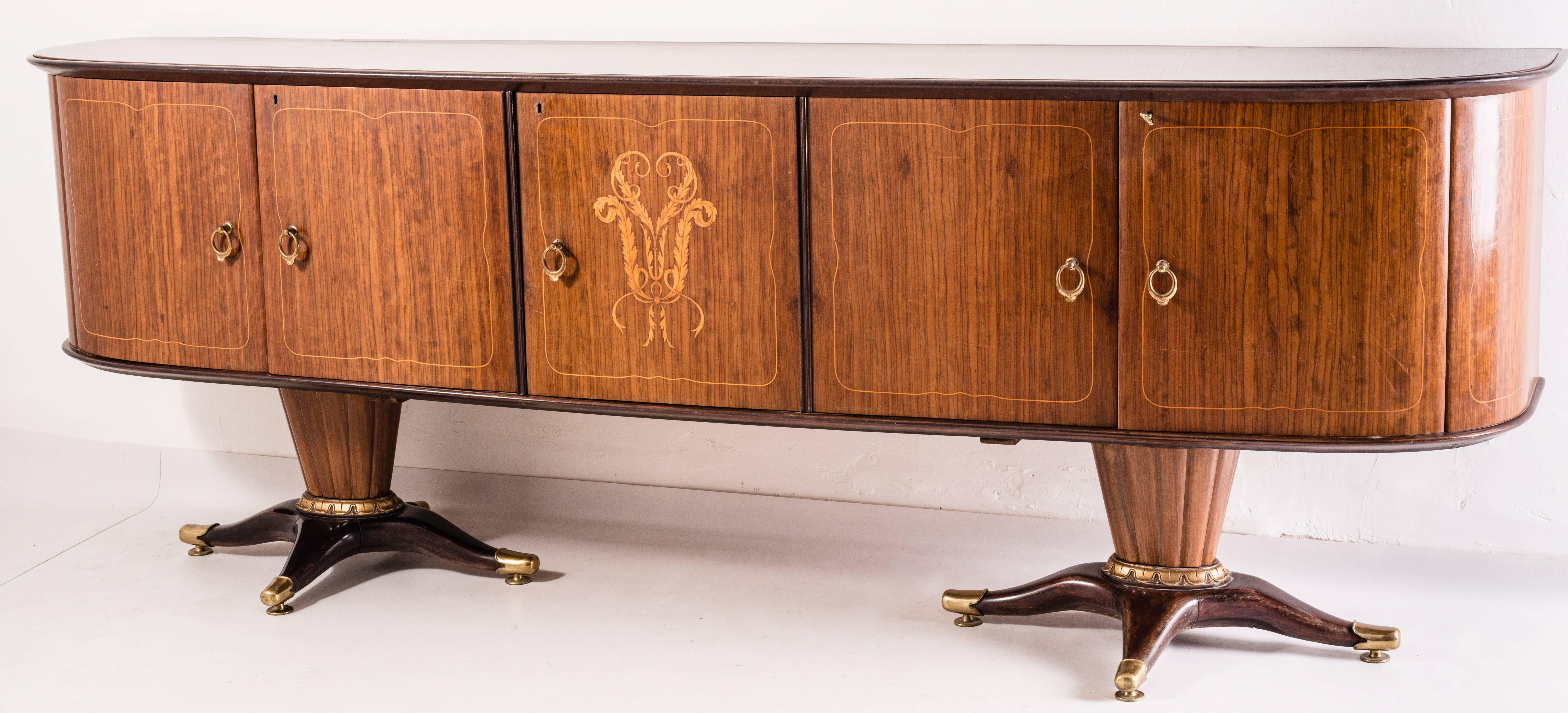 Beautiful sideboard with mirror in the style of Paolo Buffa, 1950s. The piece is really rare and important. The sideboard cabinet is supported by two major foot socks with bronze. Handmade edges around the mirror. 
The same set  is available as well
