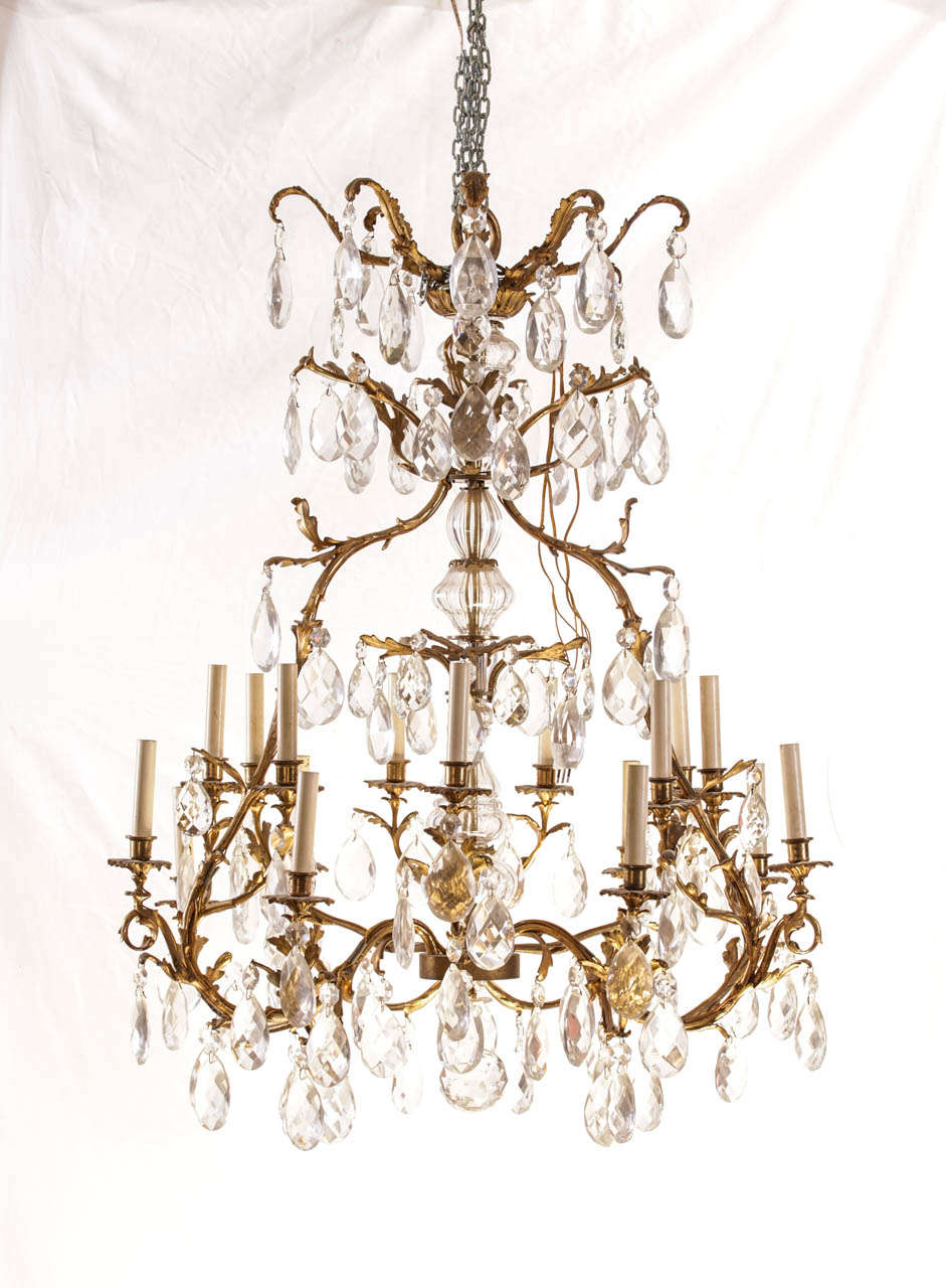 Exceptional French gilt bronze and cut-glass fourteen-light chandelier, the cage with faceted pendants.

Measures: 125 x 100 cm.