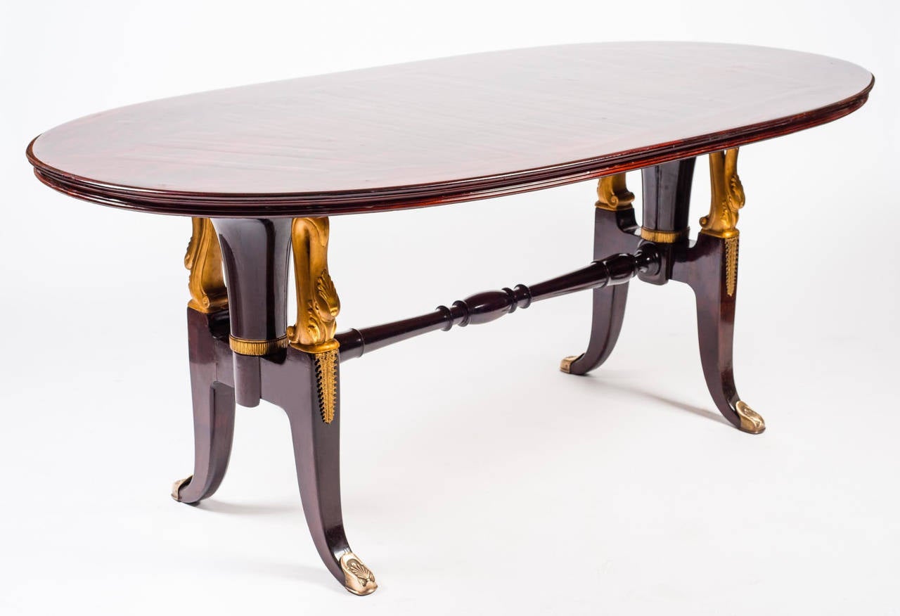 Extraordinary massive mahogany table in the style of Paolo Buffa. Finely carved decorations and finishes in gold.