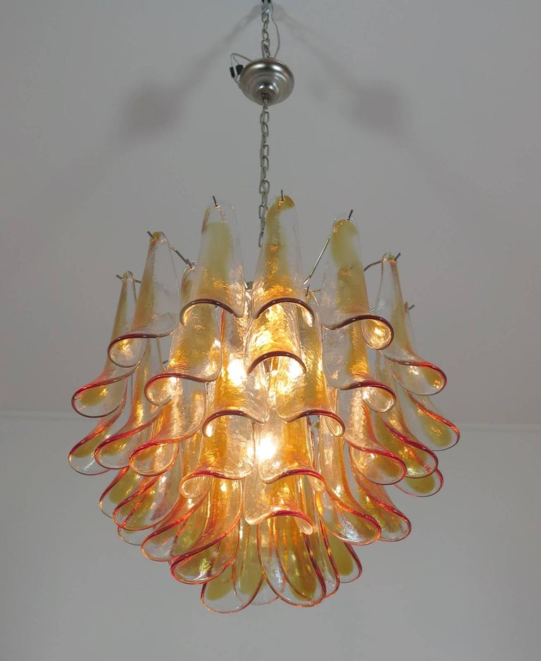 Fantastic pair of chandelier with amber glass petals, nickel-plated metal frame. It has 42 hand blown petals glass. The product is a Mazzega or La Murrina Murano. The glasses are very high quality; the photos do not do the beauty, luster of these