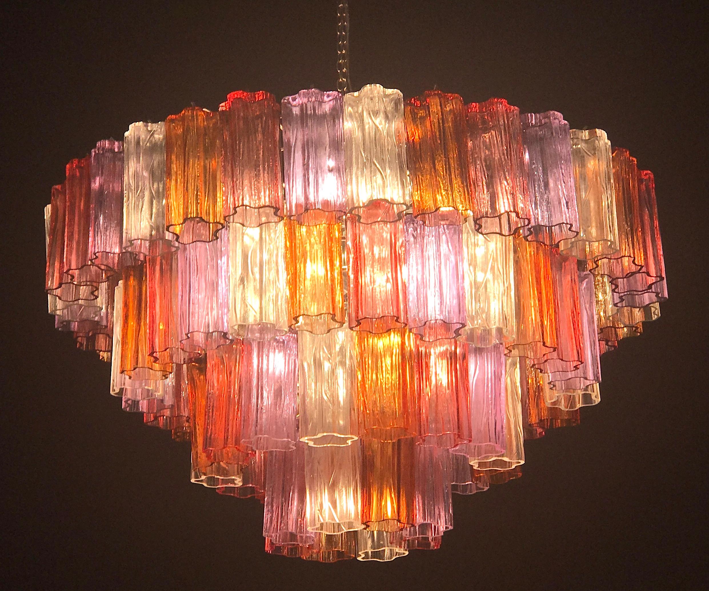 This amazing chandelier with rare color combination considering the uniqueness with amber, pink, amethyst, and ice color precious Murano glasses. Each chandelier with 80 glass blown elements supported by a chrome frame.
12 E 14 light bulbs.
