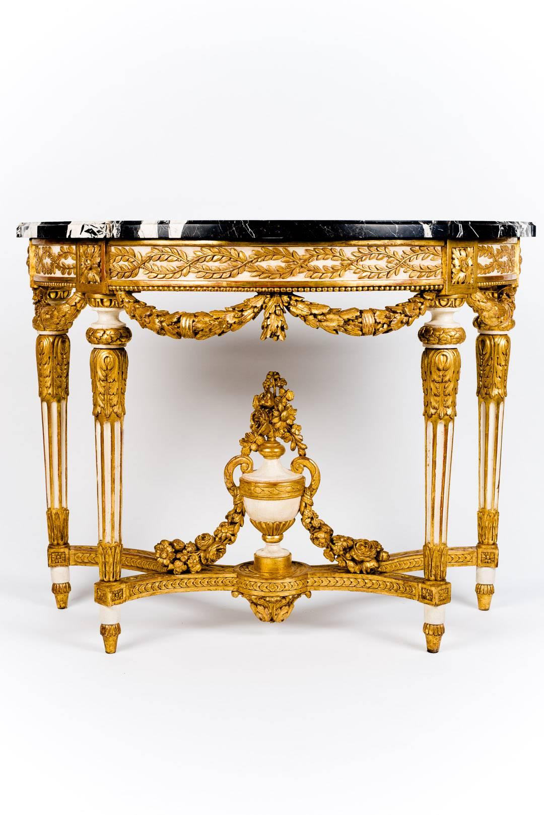 A very fine pair of Nord Italian Ivory painted and parcel-gilt console table, with a black and white 