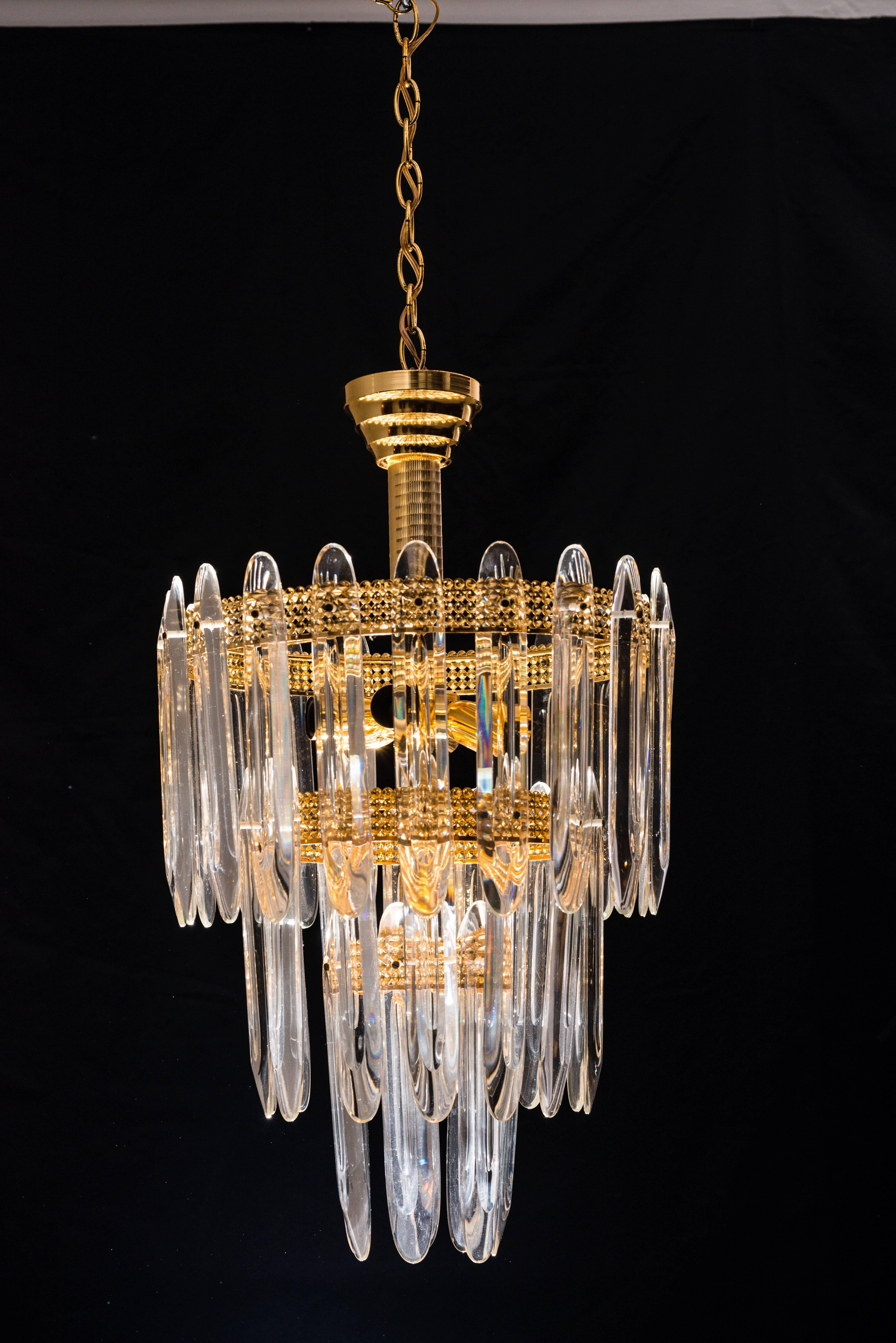 Three-tier shaped crystals on brass-plated frame. Three-tier, 13 lights.