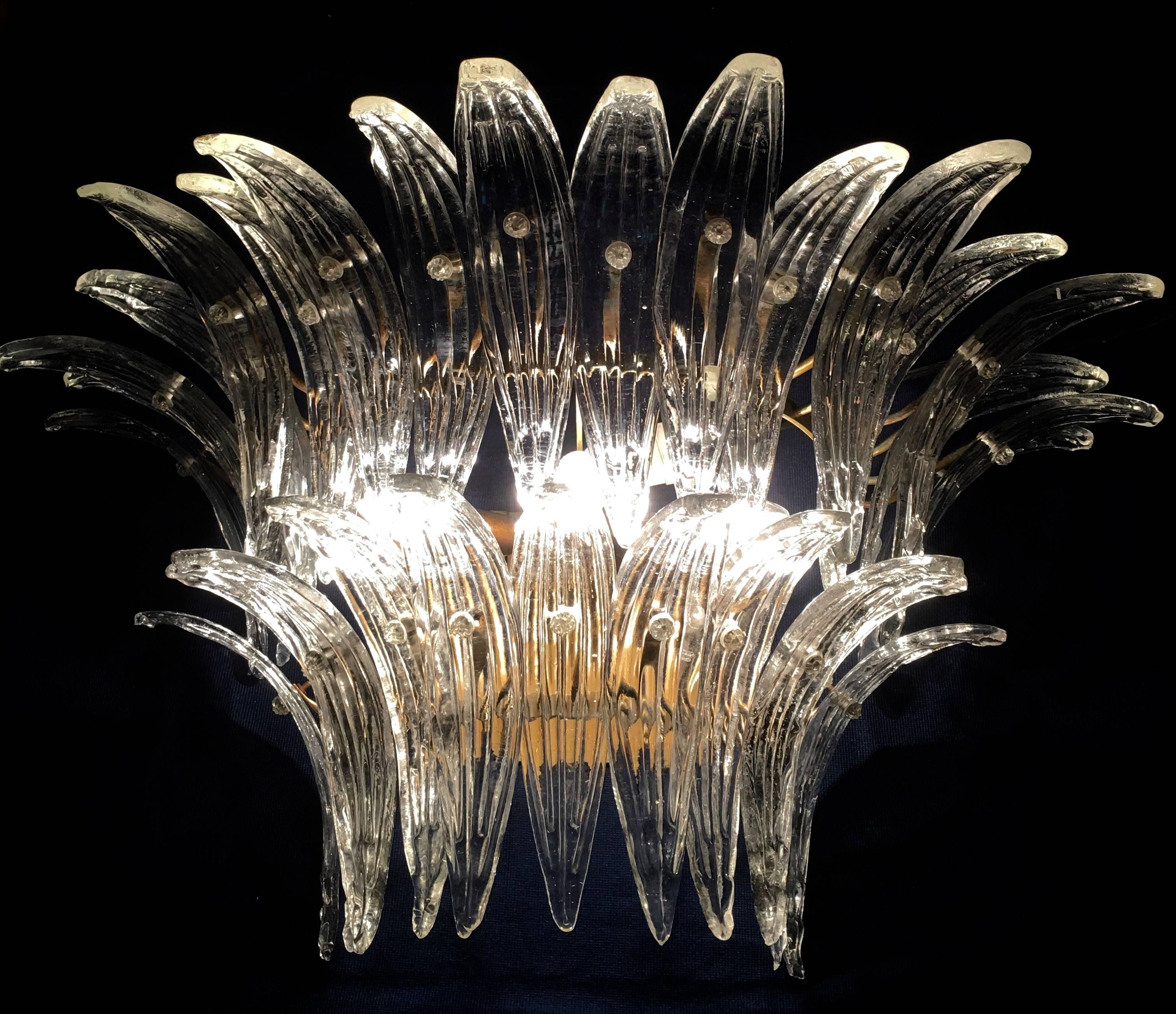 The sconces and chandeliers were located in the hall of a big hotel on the Amalfi Coast. Each individual sconce is composed by 29 large leaves in pure Murano glass. Available seven pairs of sconces and two pairs of chandeliers.