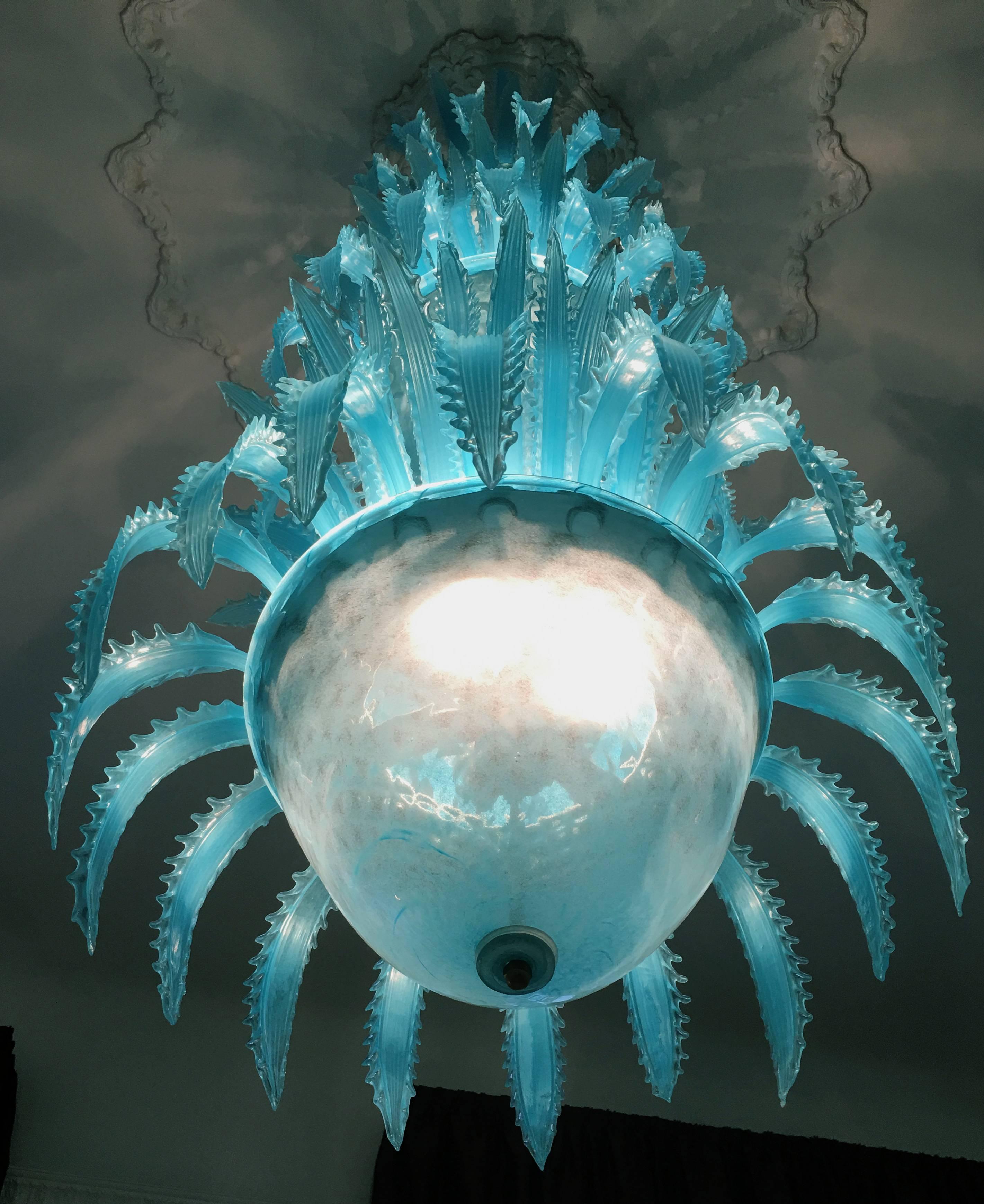 Imposing waterfall handblown glass chandelier by Murano.

Measures: Height 230 cm,
width 70 cm.
198 leaves.
Four cups.
With the same glass is available another large chandelier "Queen Torquoise" to 30 lights. It is currently