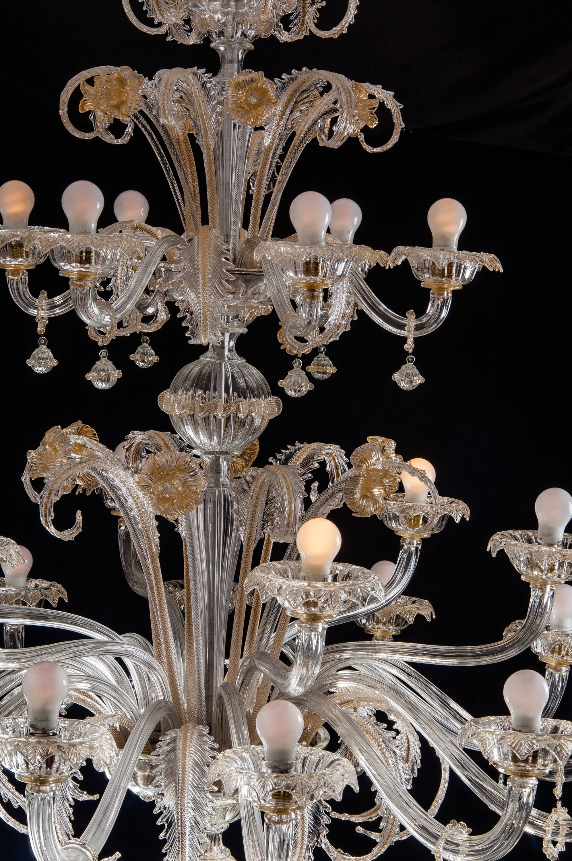 Spectacular pair of Murano chandeliers. The arms 24 are arranged on three floors. The glasses are embellished with gold inclusions.
 
