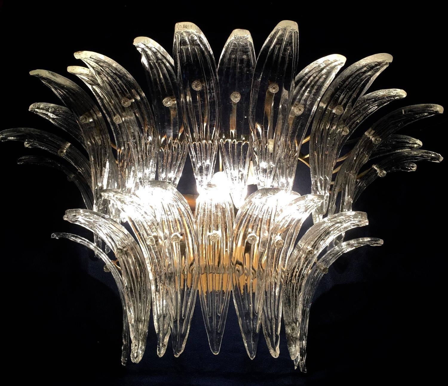The sconces and chandeliers were located in the hall of a big hotel on the Amalfi Coast. Each individual sconce is composed by 29 large leaves in pure Murano glass.