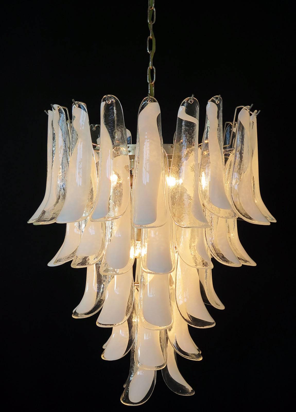 Huge Italian vintage Murano chandelier made by 52 glass petals (transparent and white “lattimo”) in a chrome.
Period: 1960s / 1970s
Dimensions: 55.10 inches (140 cm) height with chain; 29.50 inches (75 cm) height without chain; 26 inches (66