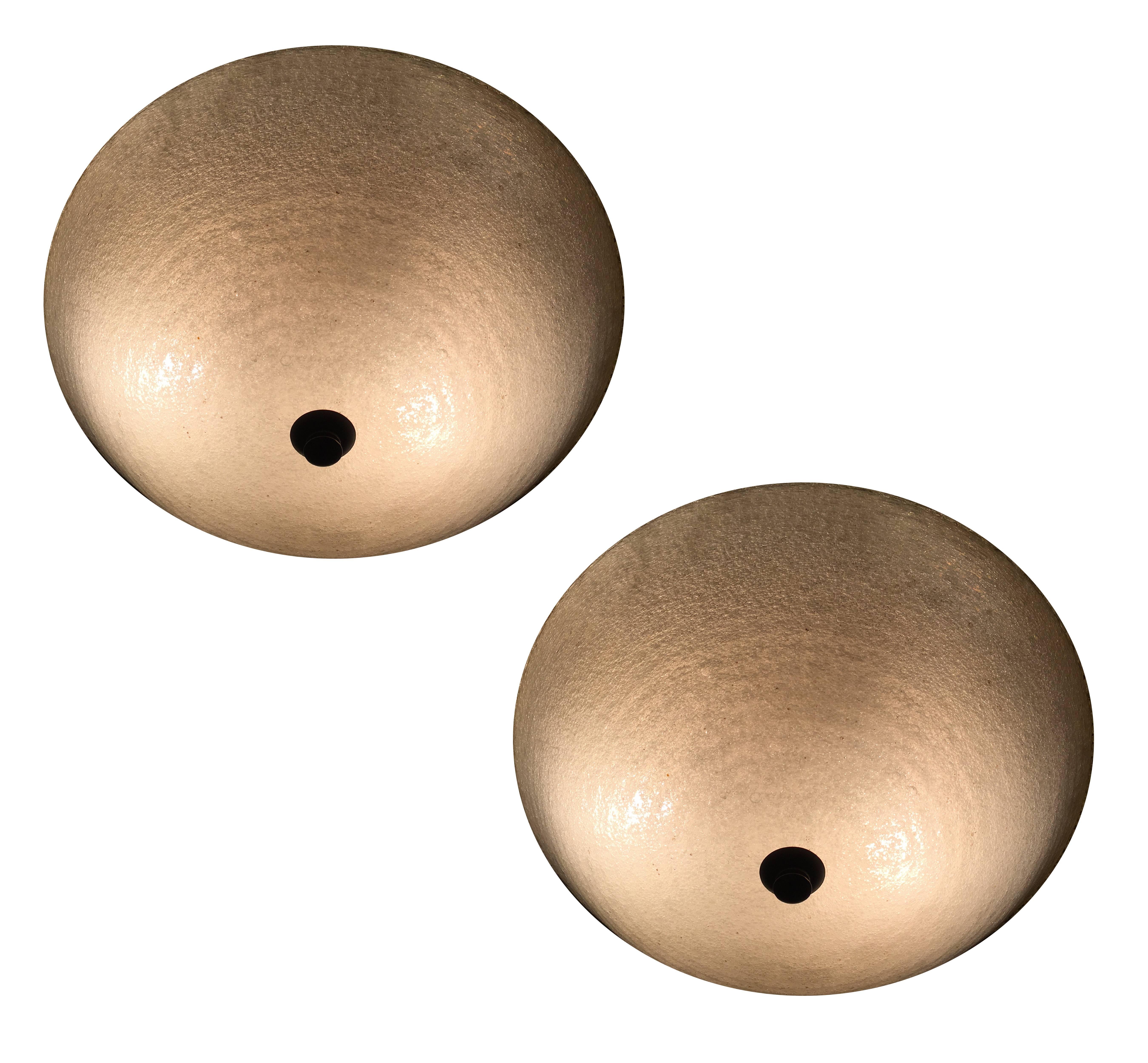Very beautiful couple of ceiling lights in 'Pulegoso' Murano glass. The mount is in brass with the patina original.