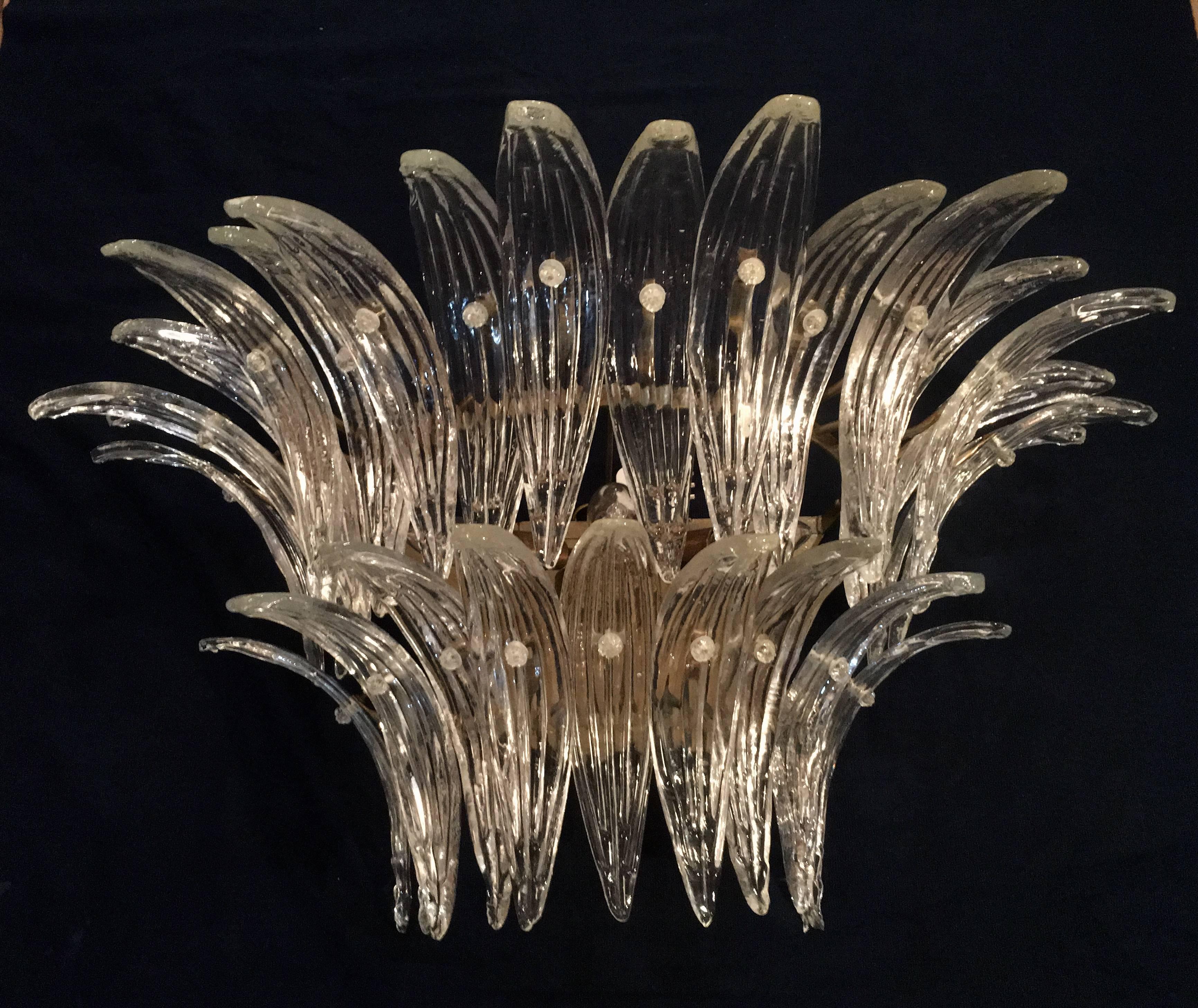 The sconces and chandeliers were located in the hall of a big hotel on the Amalfi Coast. Each individual sconce is composed by 29 large leaves in pure Murano glass. Available four pairs of sconces and two pairs of chandeliers.