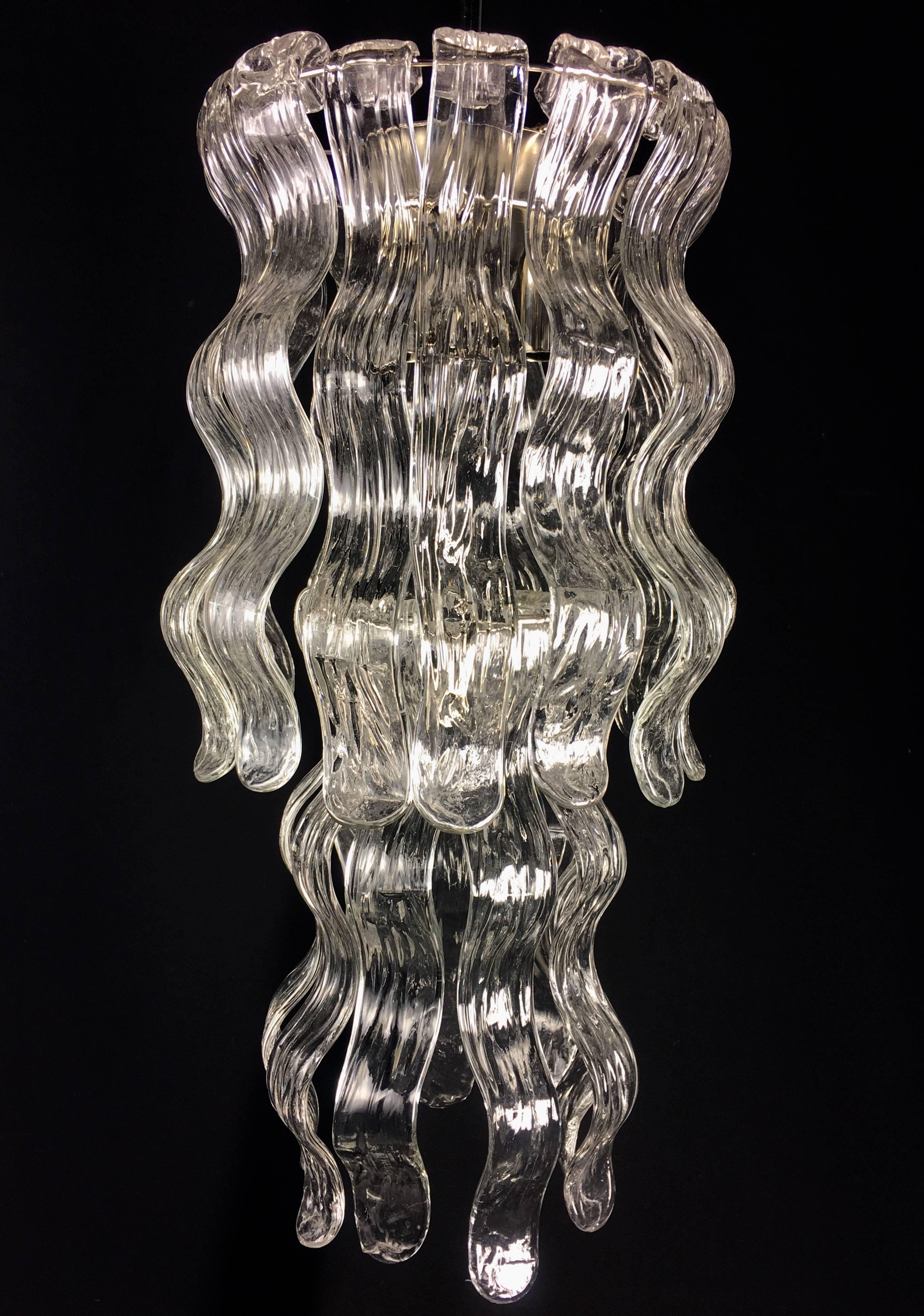 Each chandelier is composed of 24 languages ??of precious Murano glass. A 
waterfall of light to make refined each area. It is also provided the pair of larger chandeliers. From Banca di Roma in Rome.

Height 61 cm + chain
Large 30 cm.
